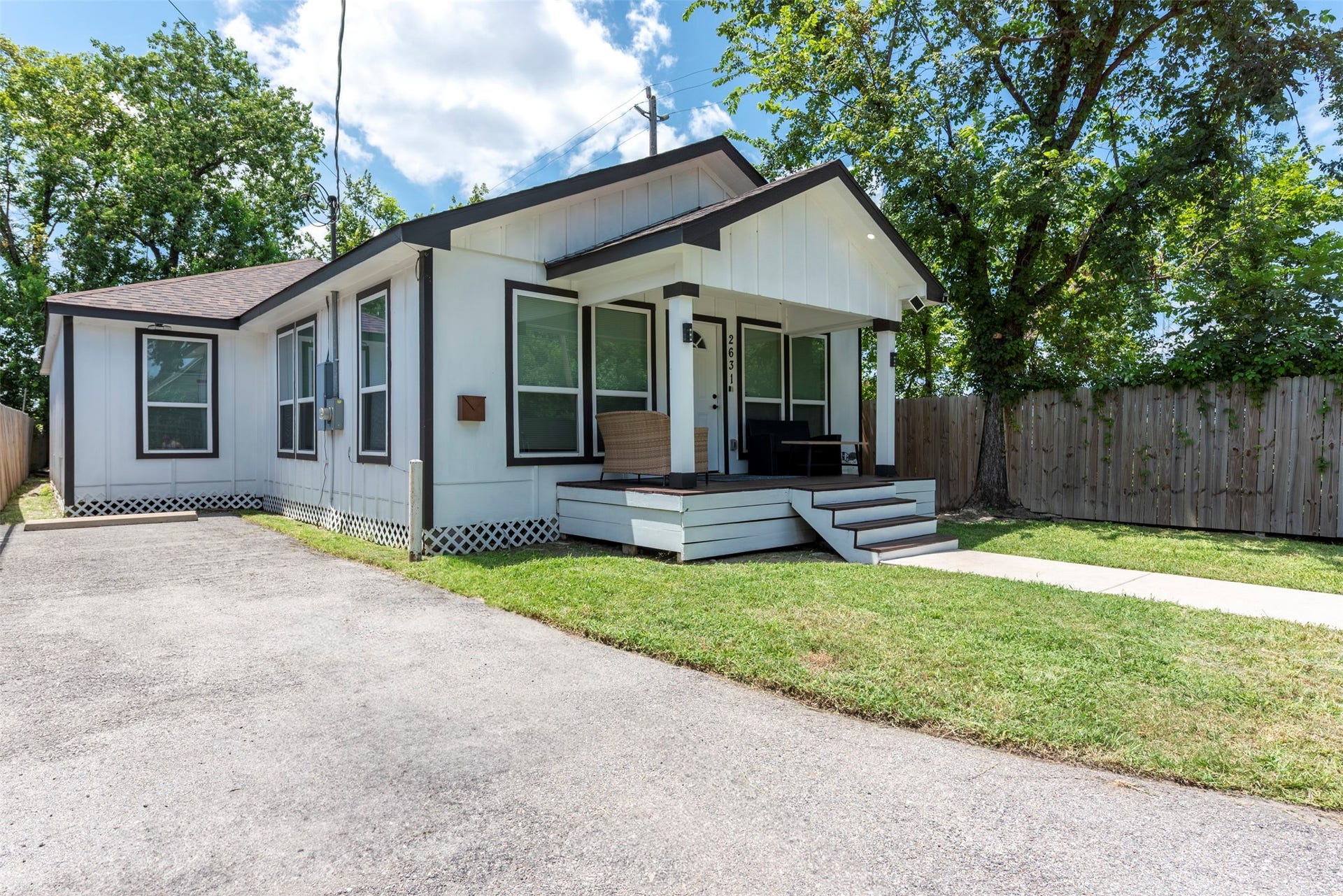 Another look at this sharp modern bungalowshowing off the clean black-and-white exterior, updated trim, and a welcoming front porch with room to lounge. Bonus: the private driveway offers plenty of space for off-street parking.