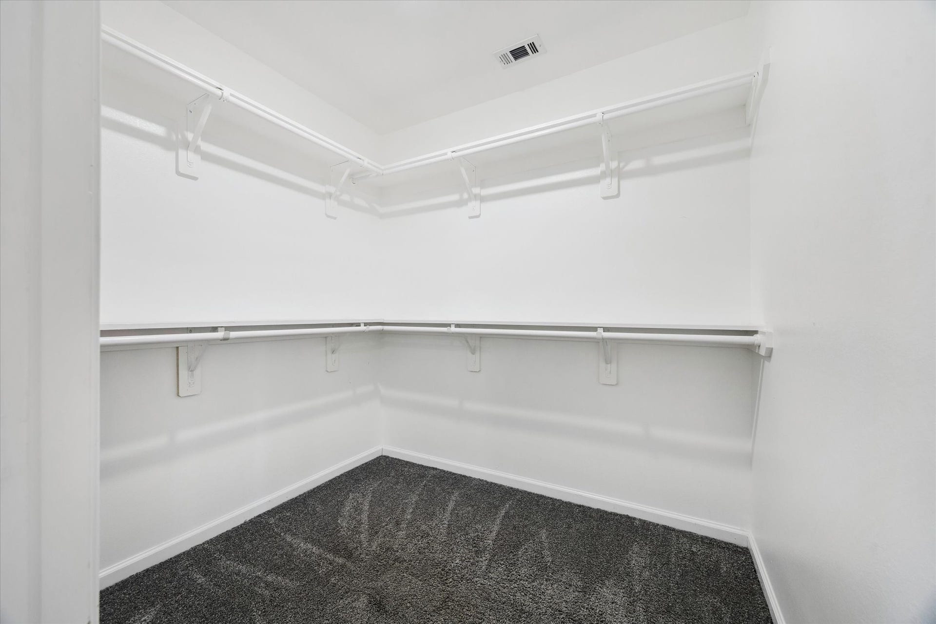 The primary suite includes a spacious walk-in closet with ample hanging space and room for easy organization. Its size makes it a true lifestyle feature, offering both function and convenience.