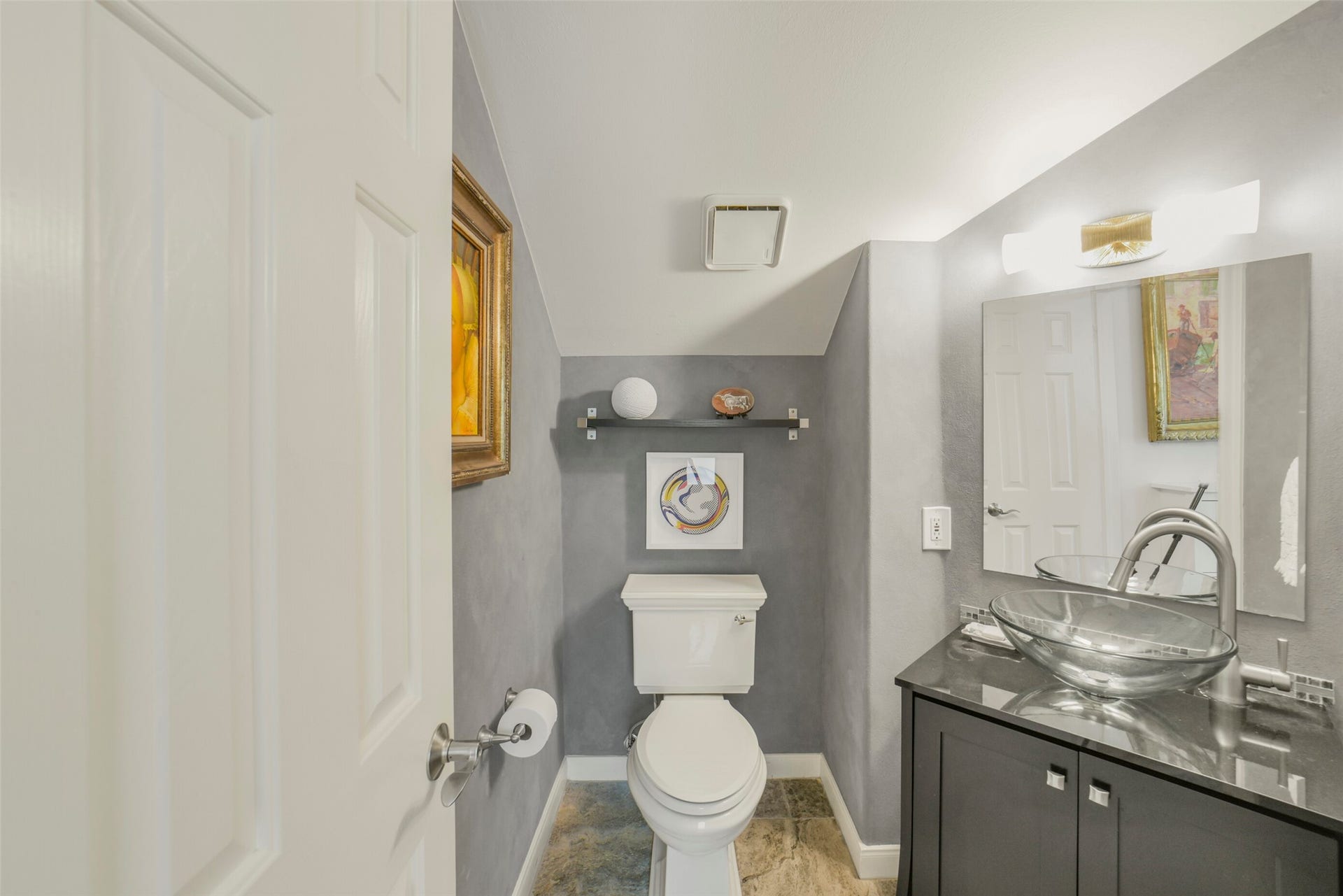 Half bathroom on the second level, tucked away from the kitchen
