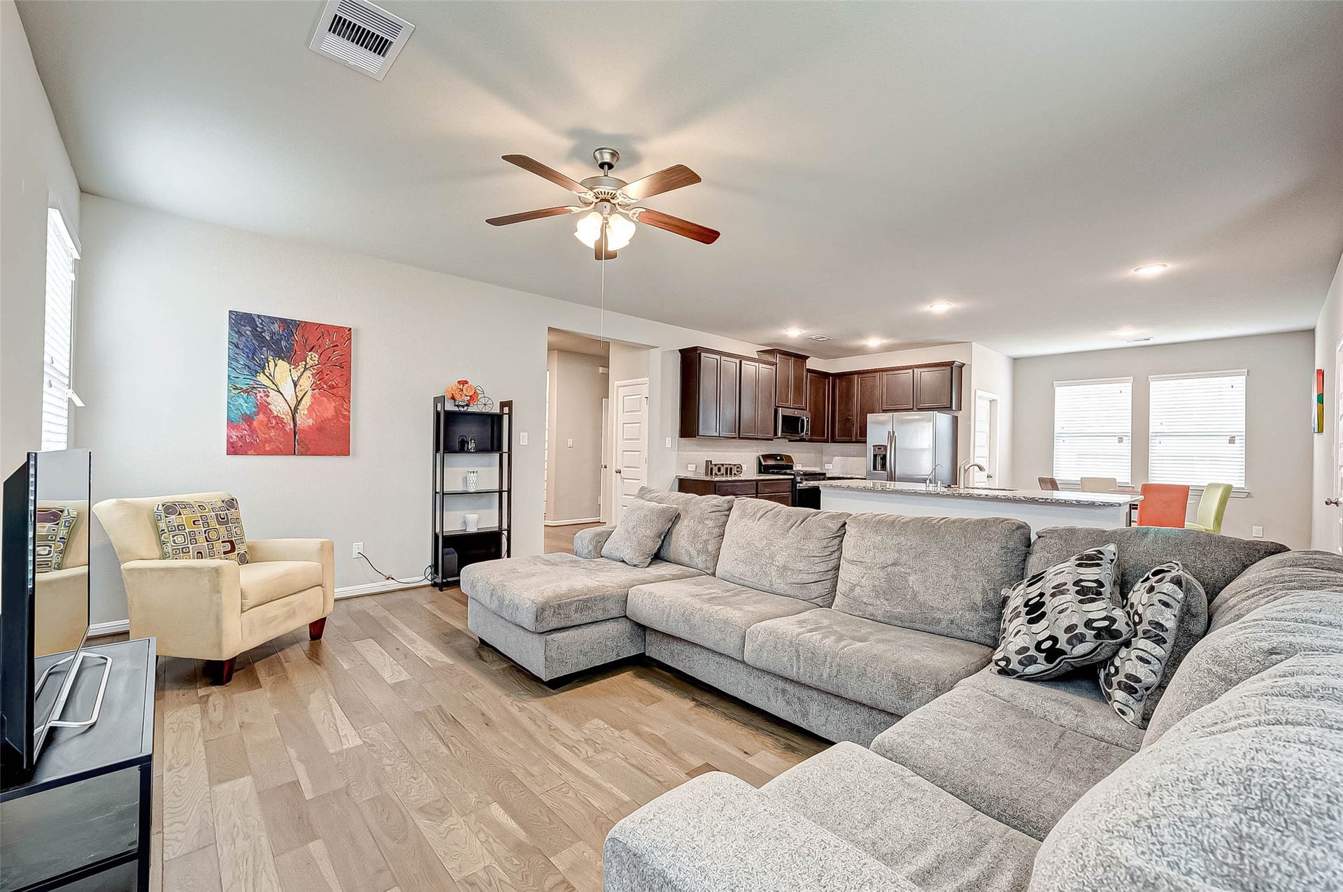 7914 Euphonia Glade Lane, Richmond, TX 77407 Open-concept living area creates an easy connection between the kitchen, dining, and gathering spaces.