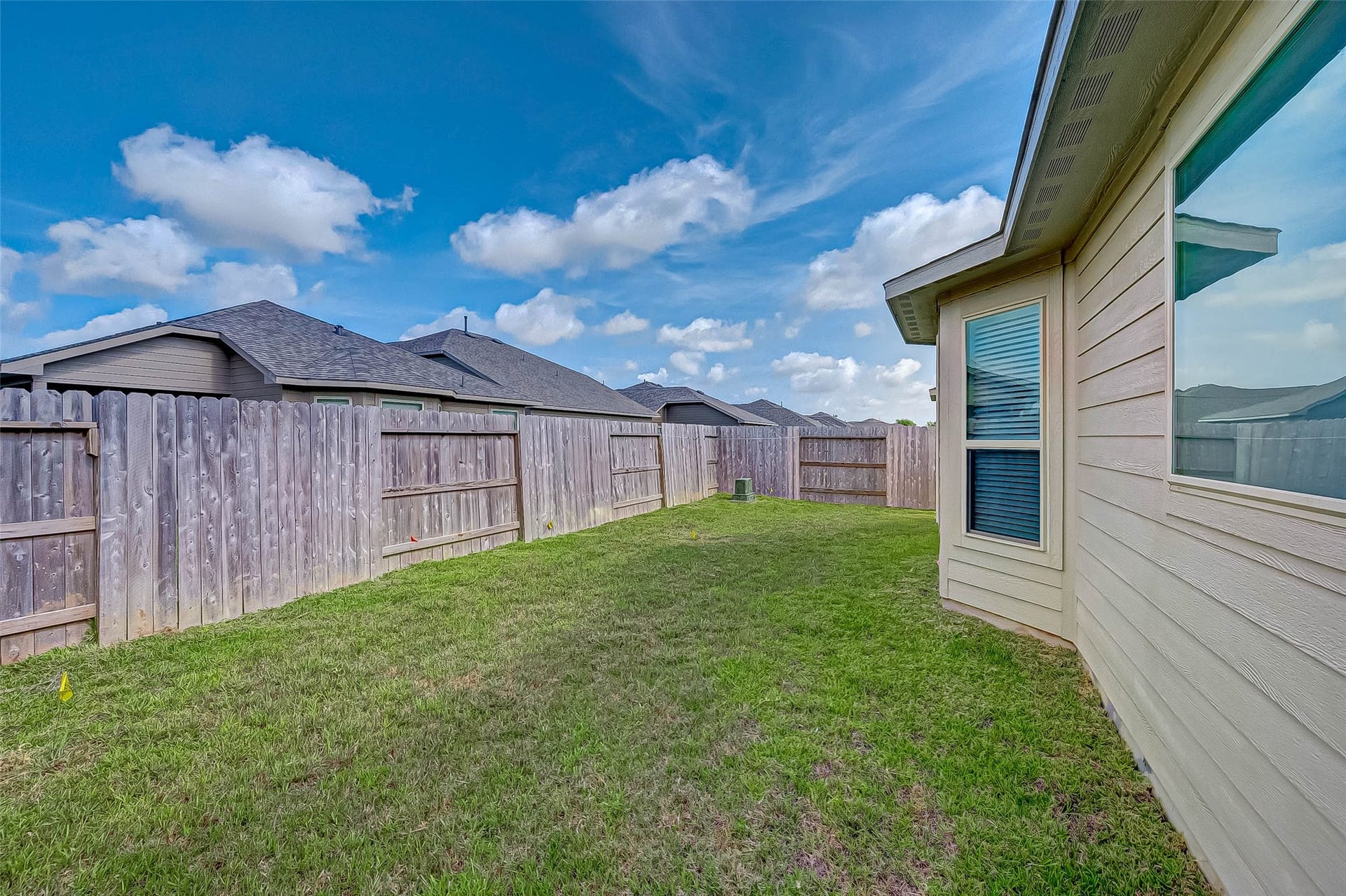 7914 Euphonia Glade Lane, Richmond, TX 77407 Rear view highlights the home's covered patio and generous backyard space.