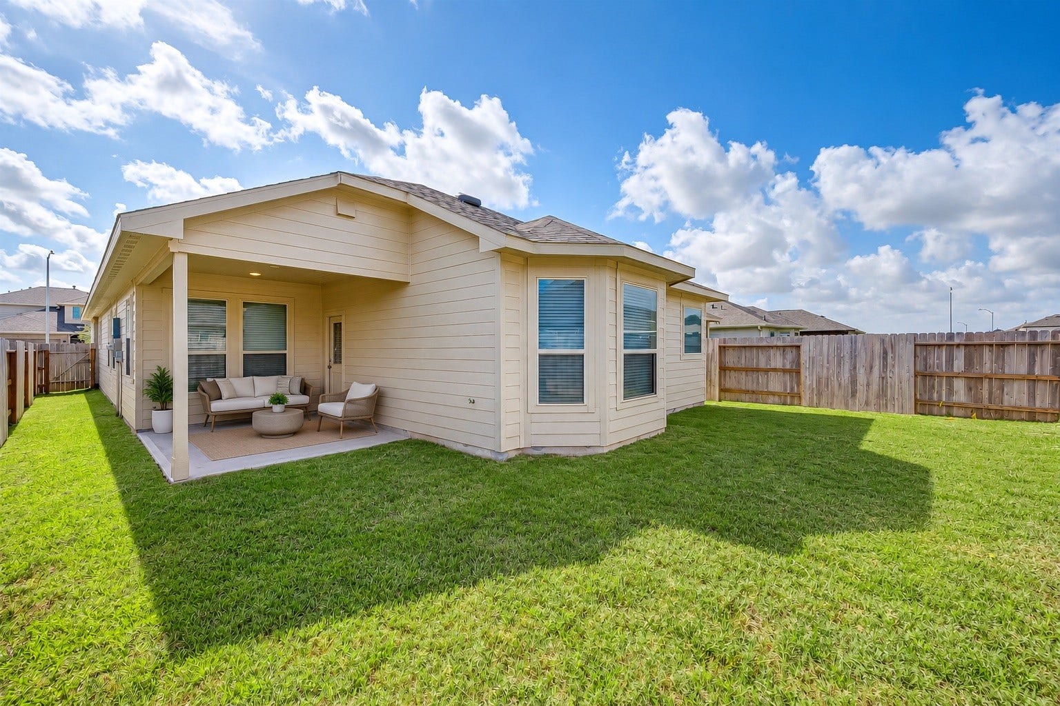 7914 Euphonia Glade Lane, Richmond, TX 77407 Virtually staged covered patio showcases the potential for a comfortable outdoor seating area overlooking the spacious fenced backyard.