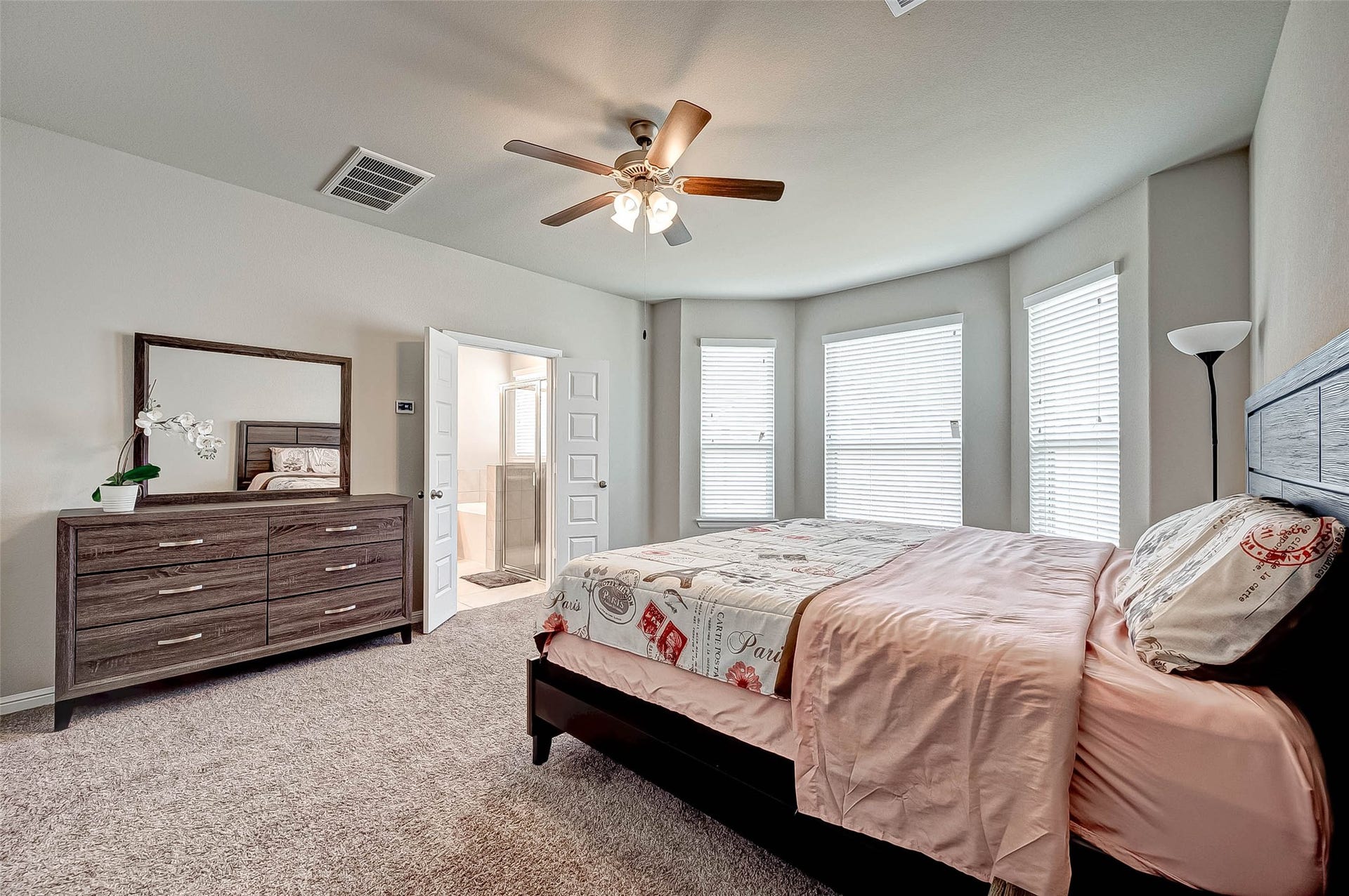 7914 Euphonia Glade Lane, Richmond, TX 77407 Spacious primary bedroom offers a comfortable retreat with neutral finishes and abundant natural light.