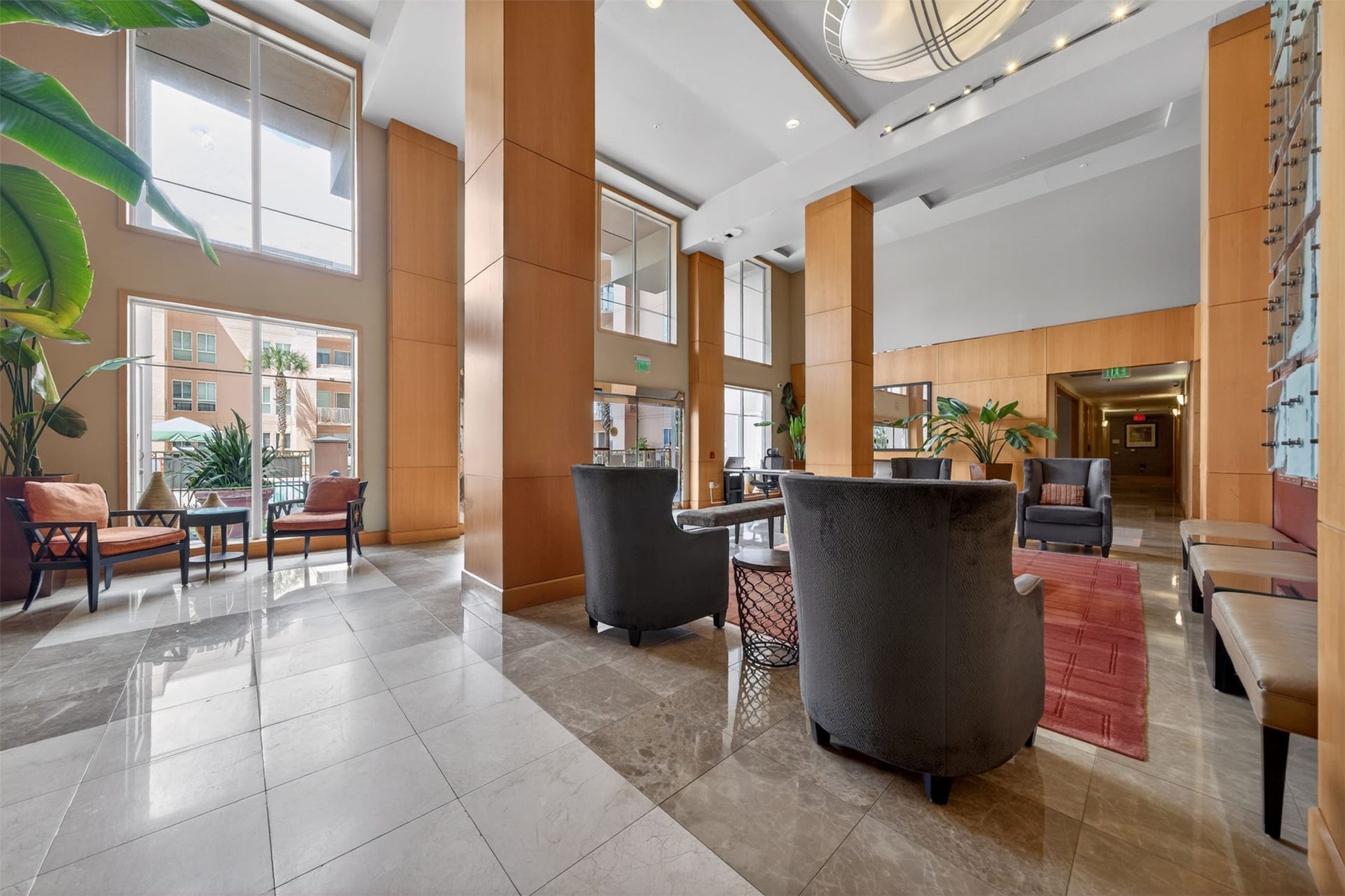3505 Sage Road, #314, Houston, TX 77056 Elegant lobby with high ceilings, abundant natural light, and stylish seating areas perfect for relaxation and socializing.