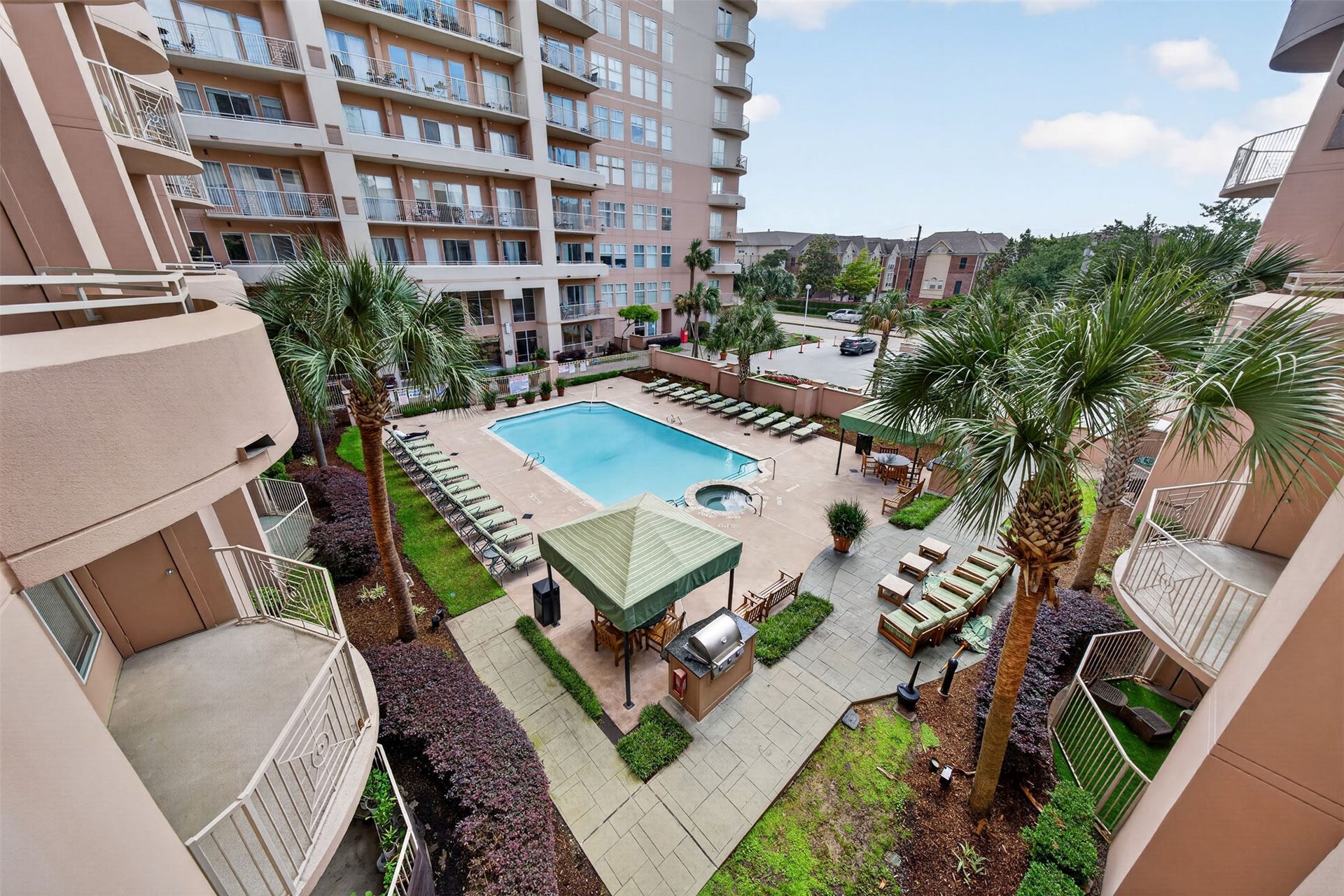 3505 Sage Road, #314, Houston, TX 77056 Enjoy resort-style living with a spacious pool, hot tub, and multiple lounging areas surrounded by lush landscaping in this luxurious condominium complex.