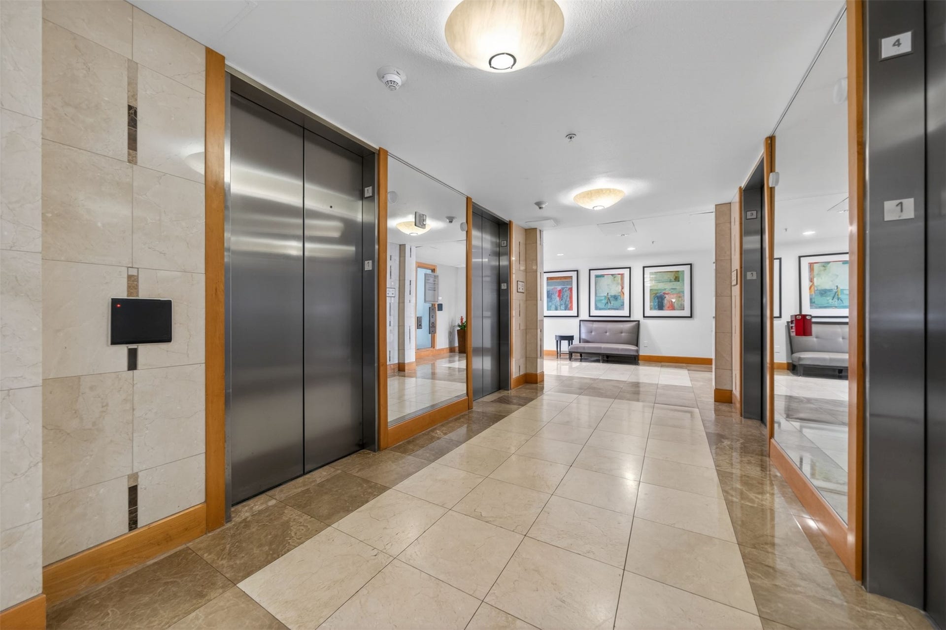 3505 Sage Road, #314, Houston, TX 77056 Elegant lobby featuring sleek elevators, polished tile flooring, modern lighting, and stylish seating, creating a welcoming and sophisticated entrance.