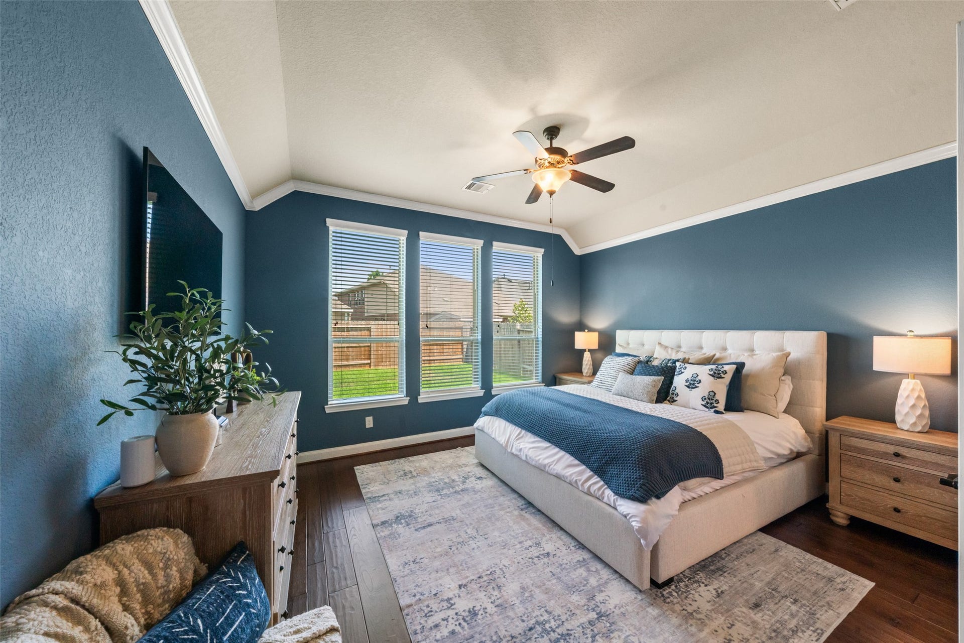 Large primary suite with view of backyard