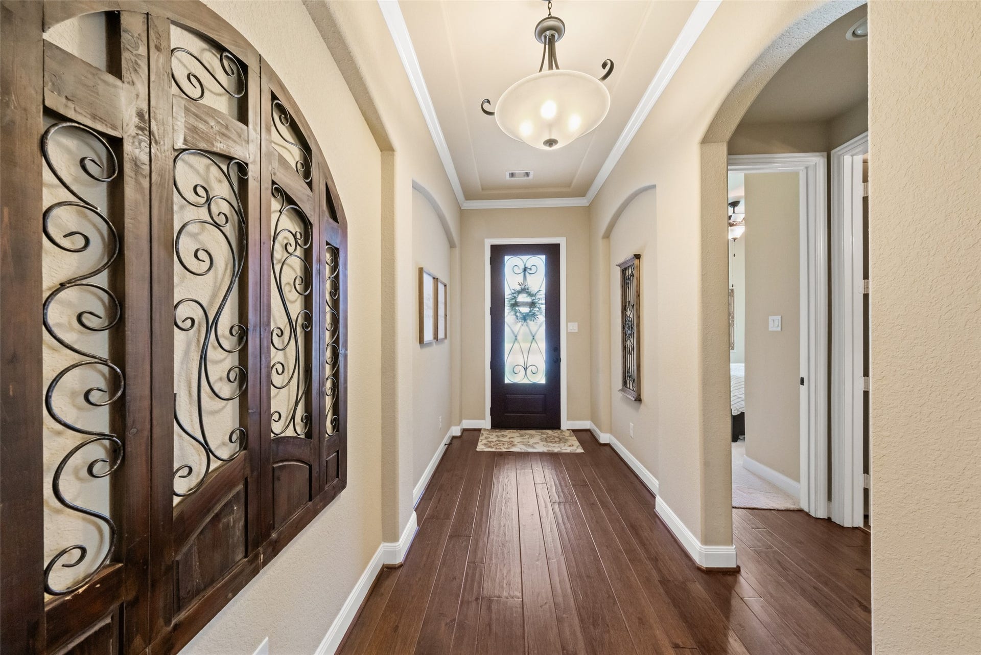 Beautiful entryway with hickory wood flooring and leaded glass door.