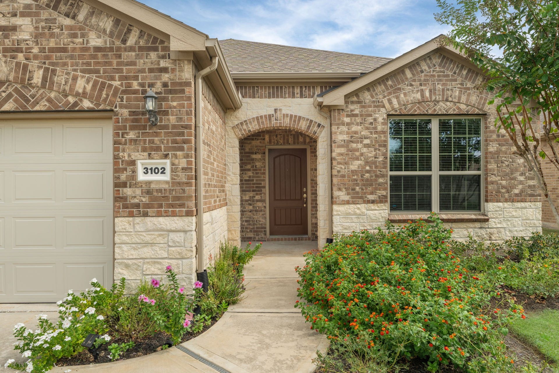 3102 Capote Peak Way, Richmond, TX 77469 Pristinely maintained landscaping makes a polished first impression before you ever step inside
