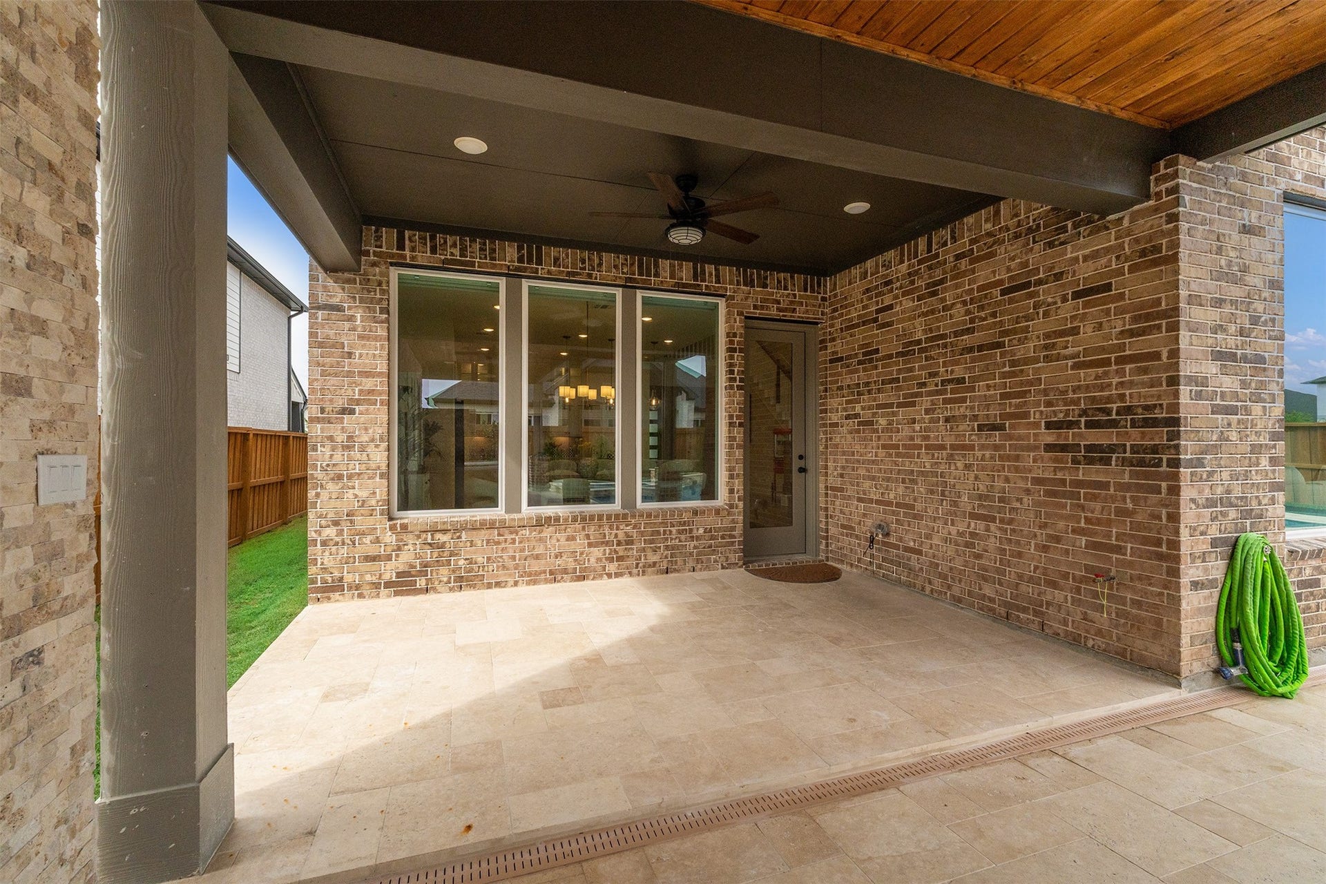 28033 Pebble Park Drive, Spring, TX 77386 Spacious covered patio with fan and Travetine floors.