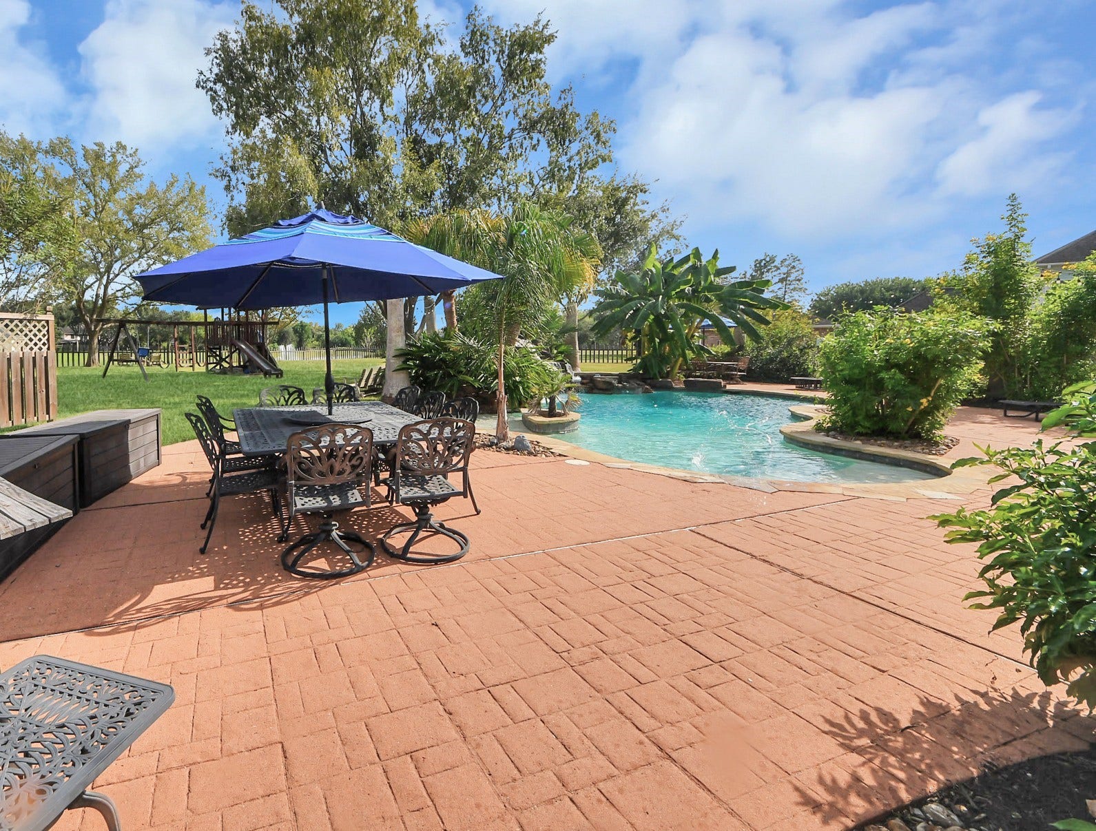 3903 Indian Point, Missouri City, TX 77459 Extensive decking around pool area allows for multiple4 seating and dining vignettes for guests