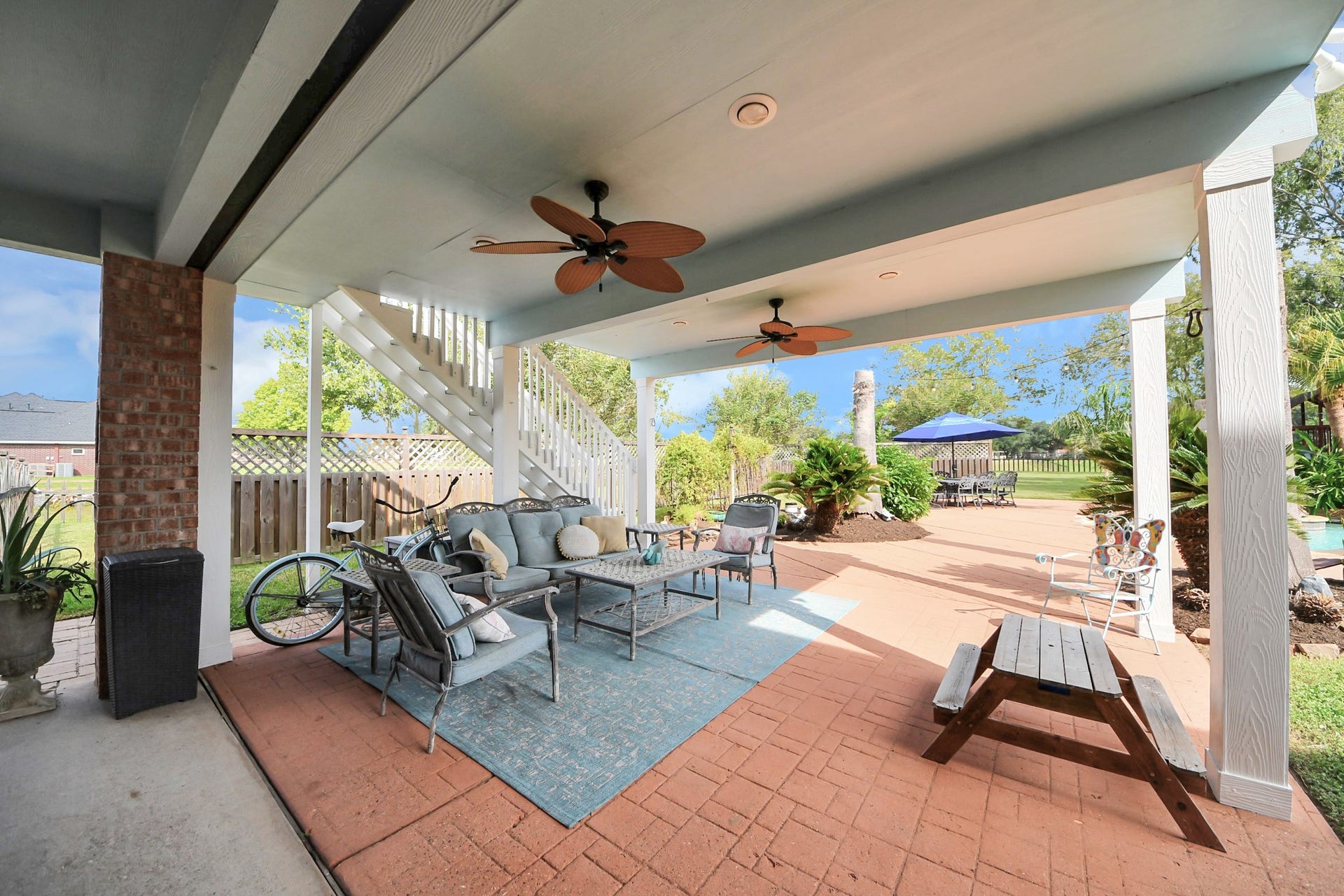 3903 Indian Point, Missouri City, TX 77459 Covered patio area off of the breakfast room, showing exterior staircase that leads to upstairs deck balcony and gameroom entrance