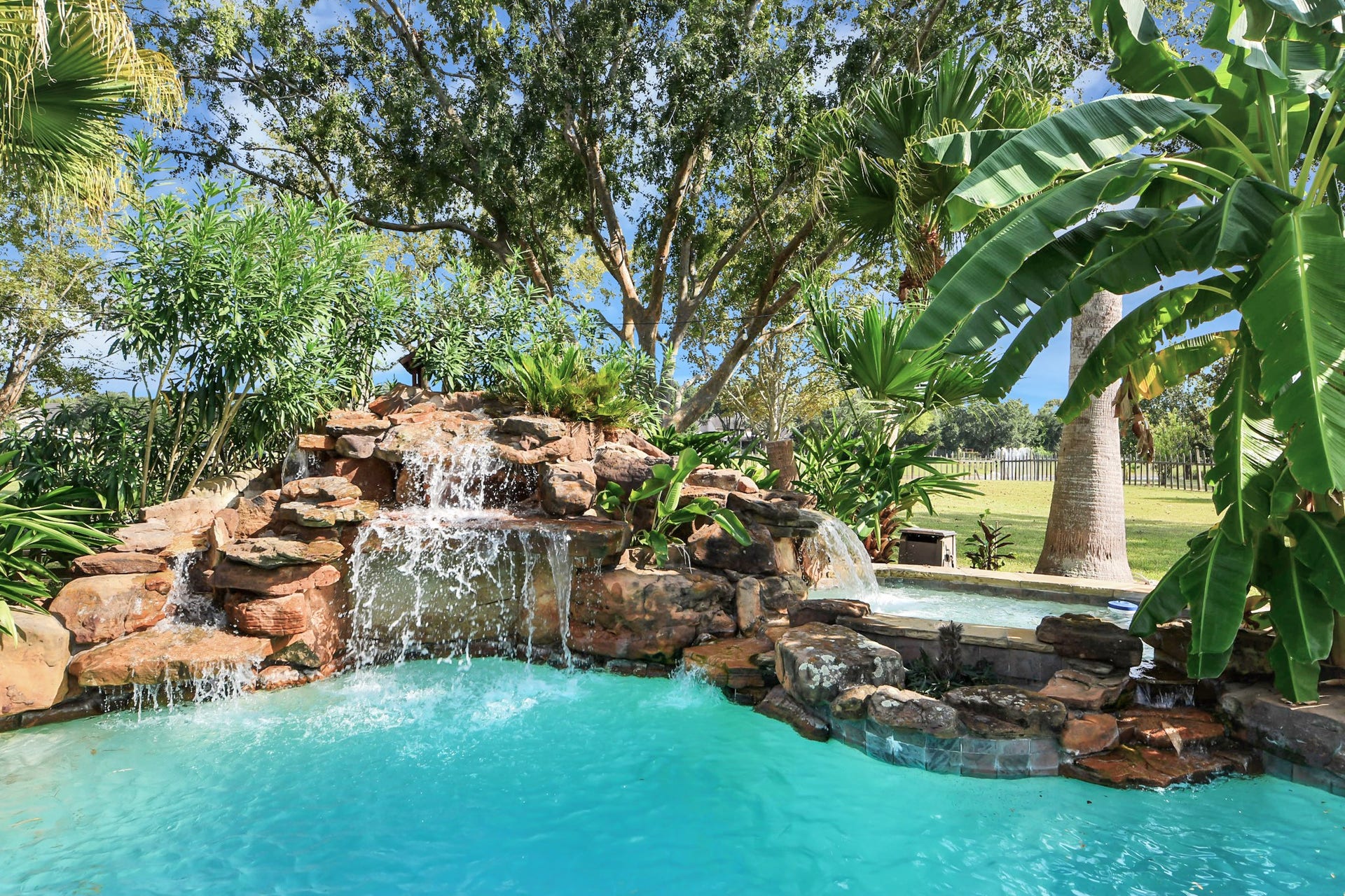 3903 Indian Point, Missouri City, TX 77459 Waterfall with rock formations above an 8' pool depth for jumping