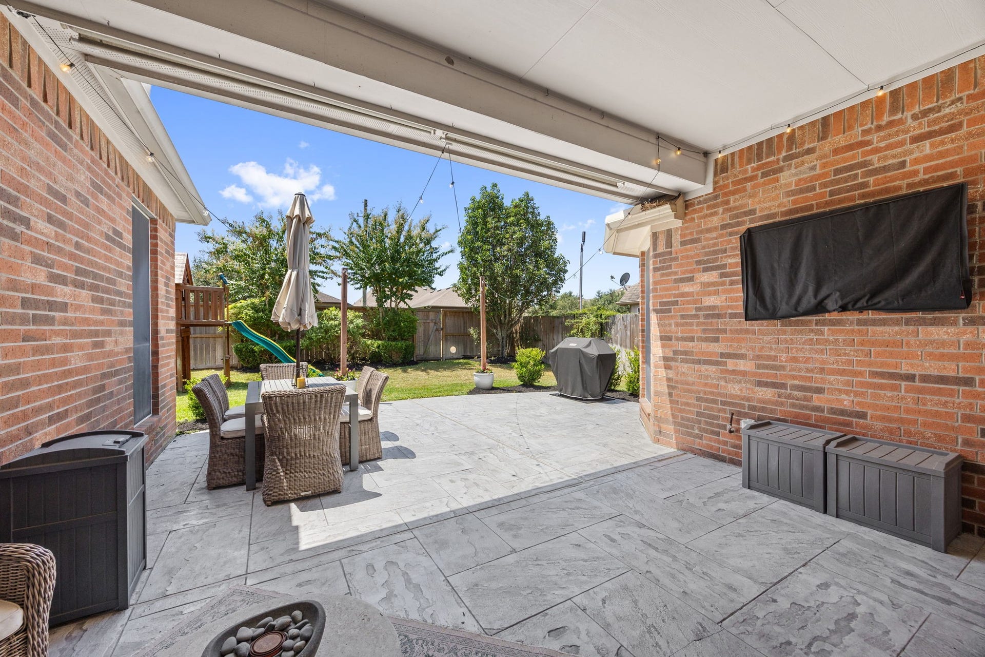 26823 Sandy Arbor Lane, Katy, TX 77494 Expansive covered patio provides an extension of the home with generous space for outdoor seating, dining, or entertaining while overlooking the backyard.