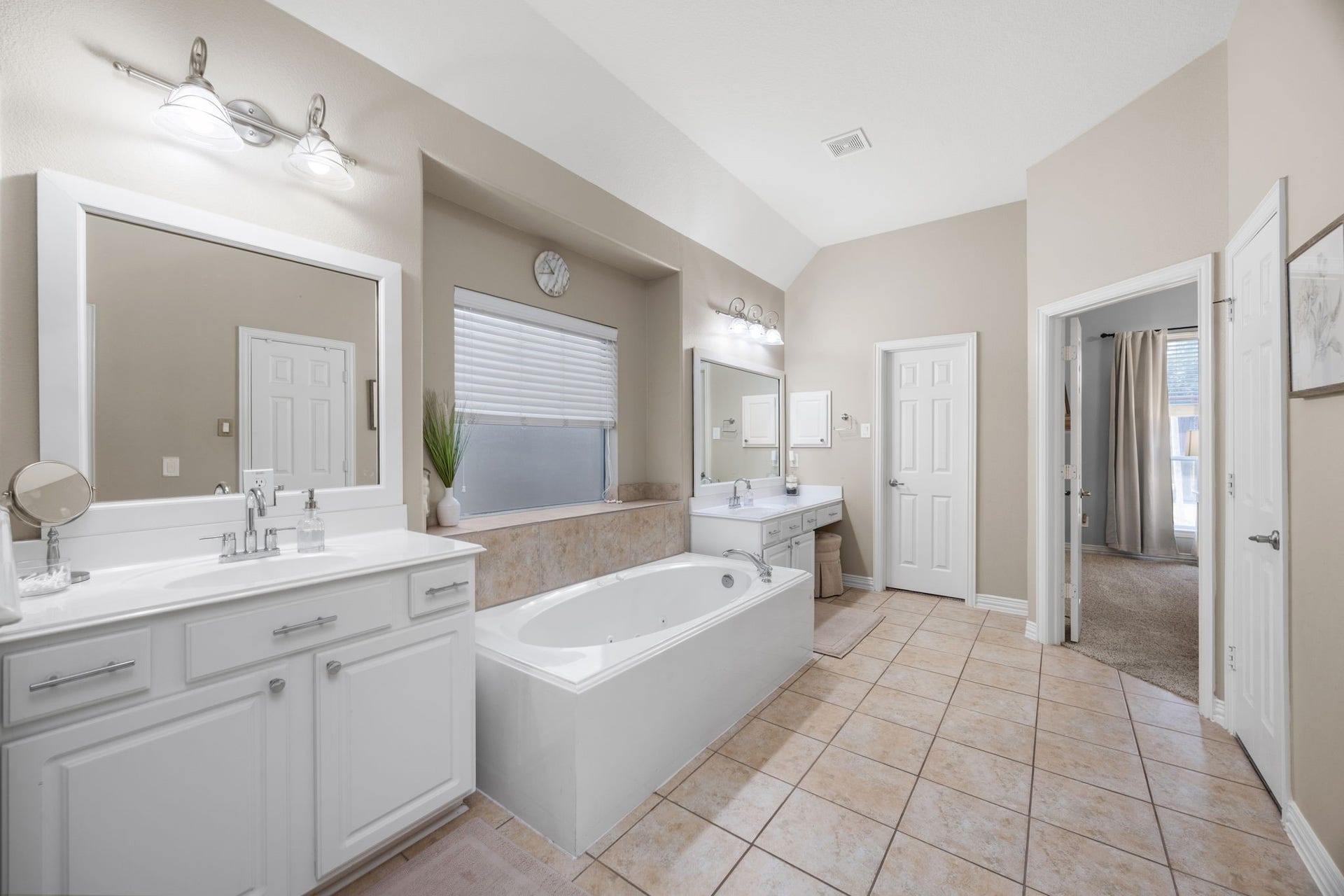 26823 Sandy Arbor Lane, Katy, TX 77494 A second view of the primary bath shows the generous layout with separate vanities, framed mirrors, soaking tub and access to the primary suite.