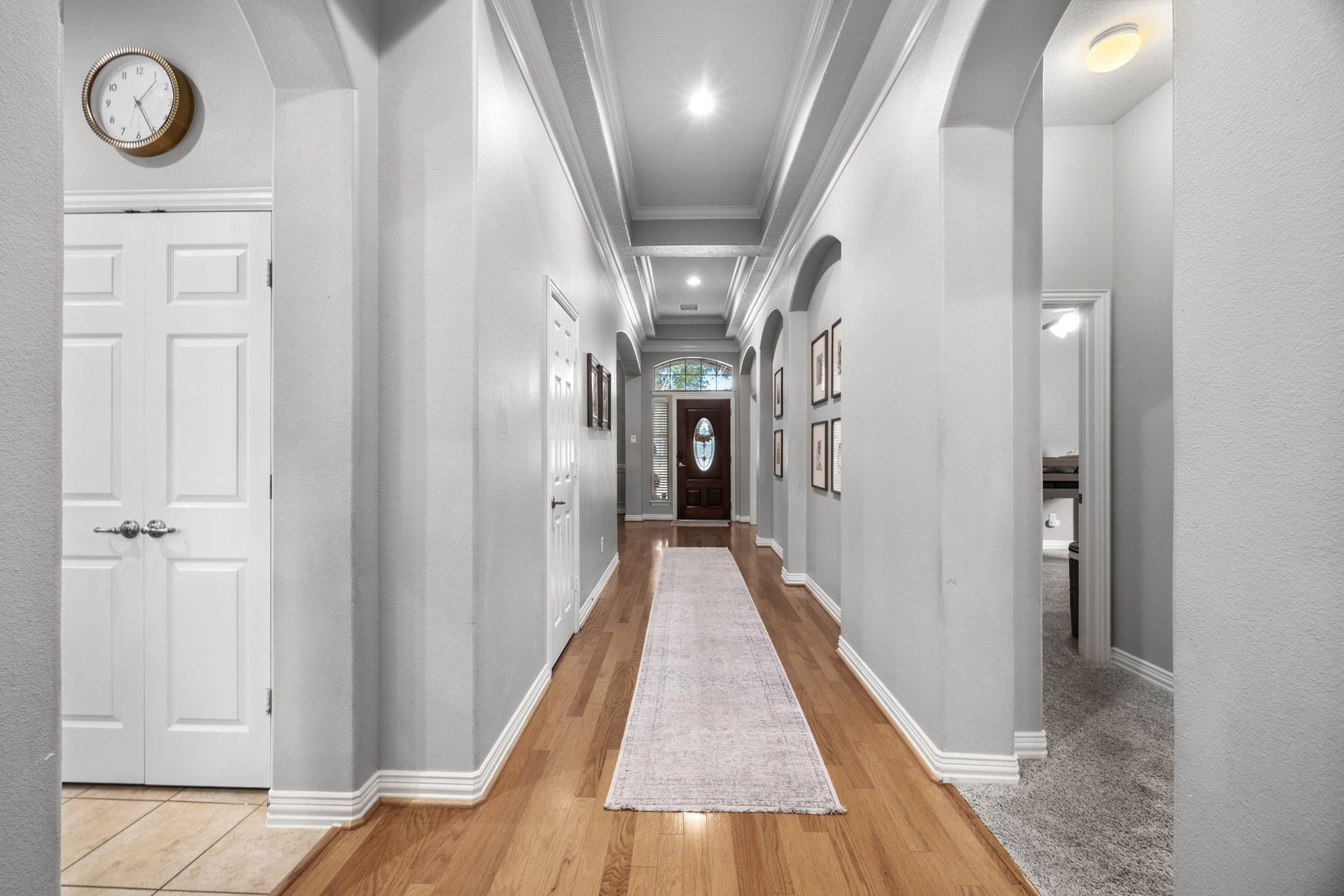 26823 Sandy Arbor Lane, Katy, TX 77494 A long central gallery with architectural arches and detailed ceiling treatment connects the home while helping define its desirable layout.