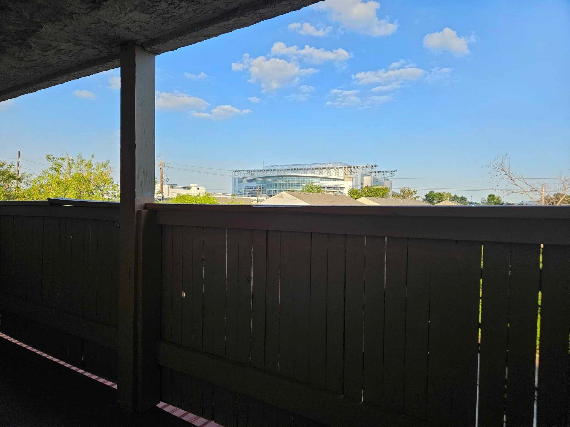 8433 Hearth Drive, #38, Houston, TX 77054 Relax in the Balcony with breath taking view of the sky and NRG Stadium building.