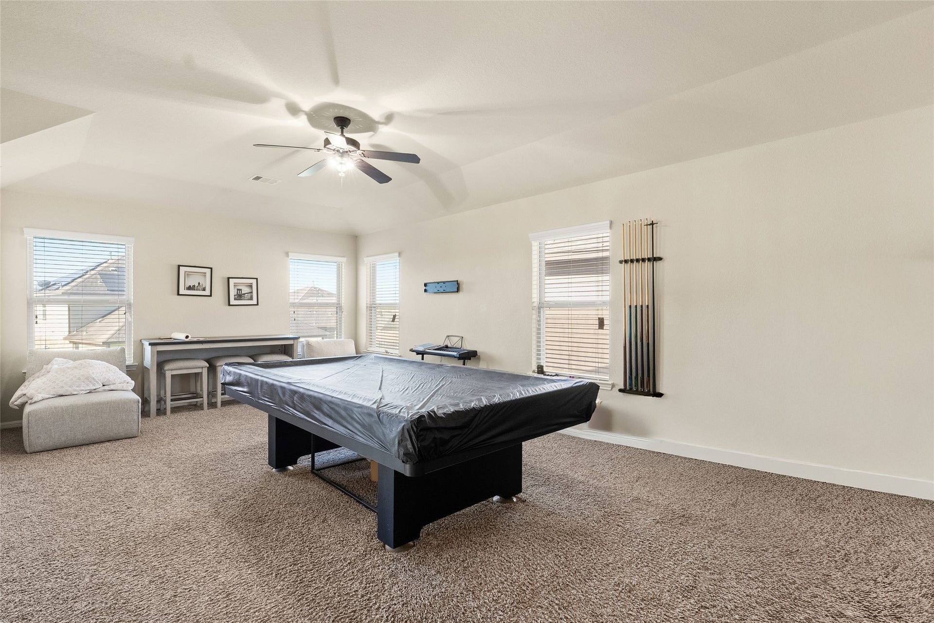 3650 Daintree Park Drive, Katy, TX 77494 Spacious game room featuring a central pool table, plush carpeting, and ample natural light from multiple windows, ideal for entertainment and relaxation.