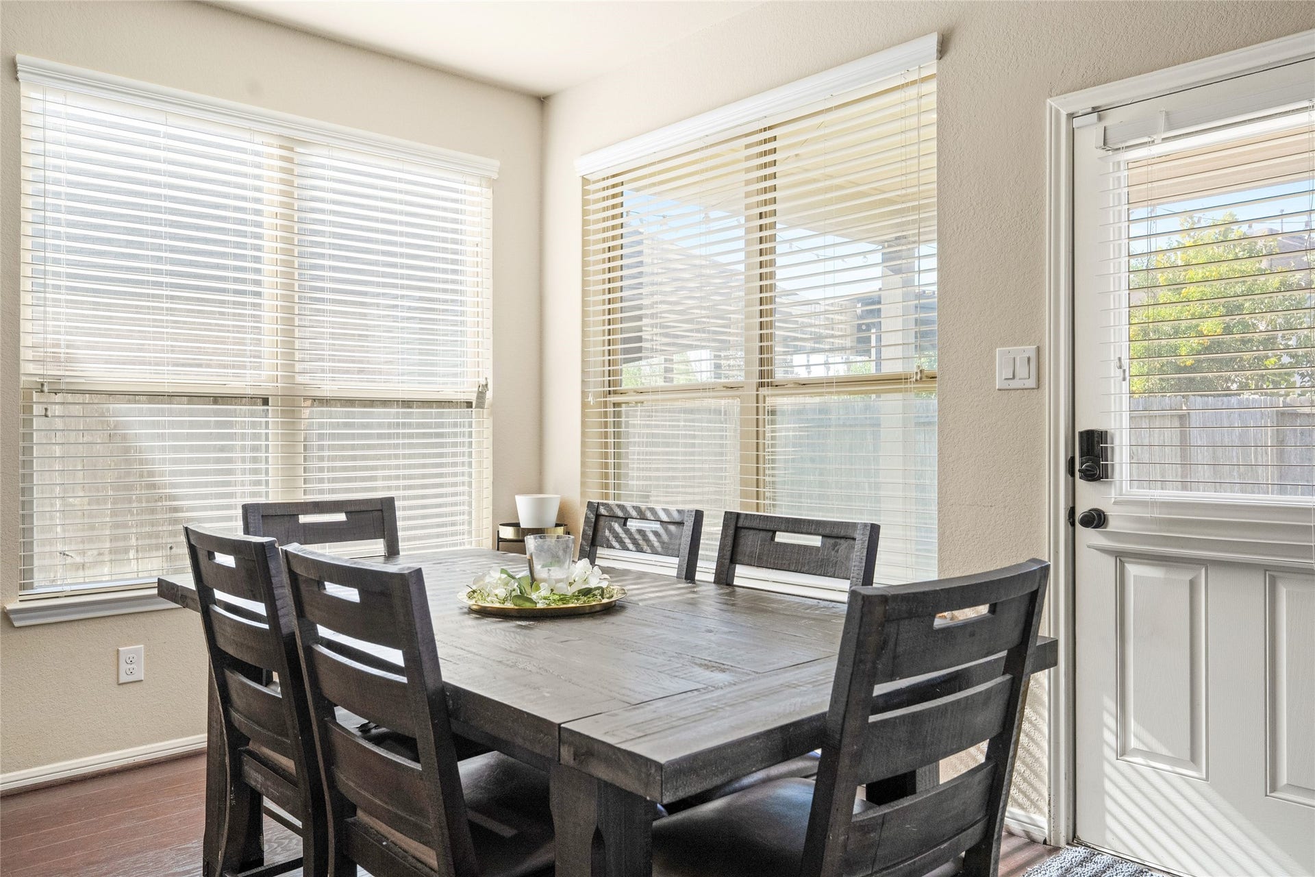 3650 Daintree Park Drive, Katy, TX 77494 Bright dining area featuring large windows and a charming wooden table, perfect for family gatherings.