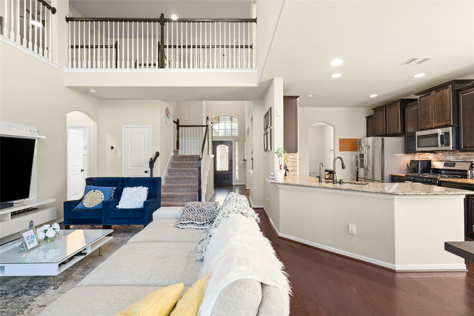 3650 Daintree Park Drive, Katy, TX 77494 Spacious open-concept living area with high ceilings, a cozy loft, and a modern kitchen featuring granite countertops and stainless steel appliances.
