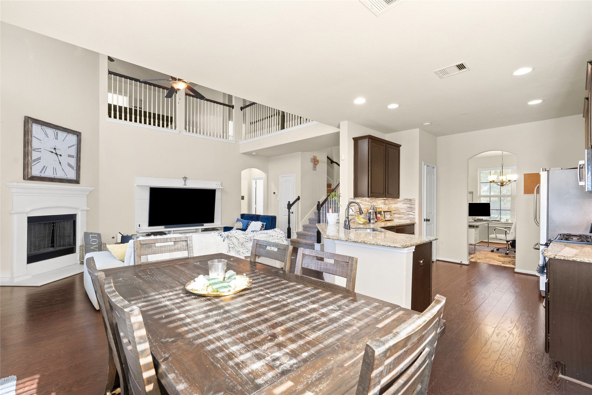 3650 Daintree Park Drive, Katy, TX 77494 Spacious open-concept living area with high ceilings, featuring a cozy fireplace, modern kitchen with granite countertops, and ample natural light.