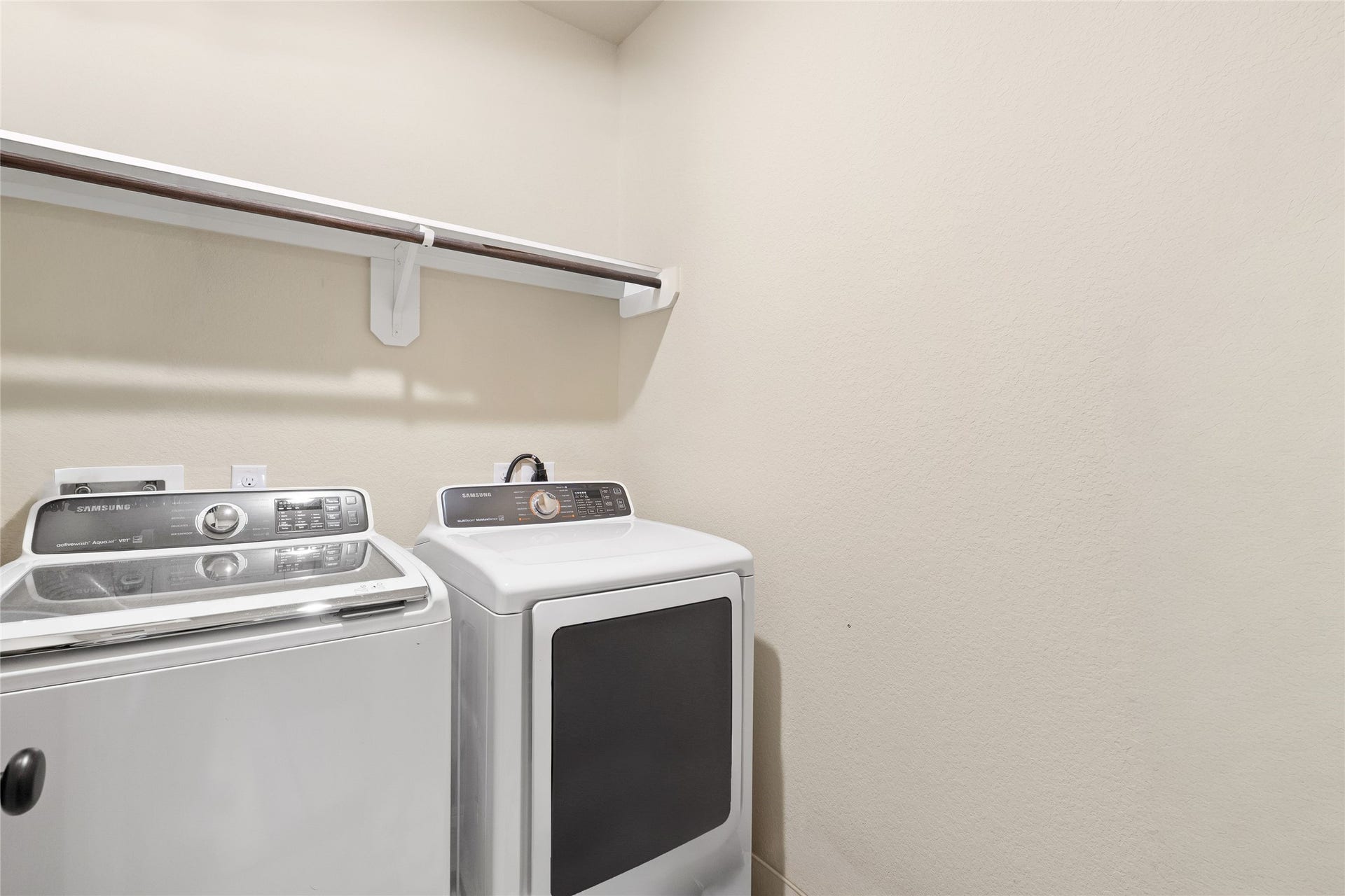 3650 Daintree Park Drive, Katy, TX 77494 Spacious laundry room equipped with modern washer and dryer, complemented by a convenient overhead shelf for storage.