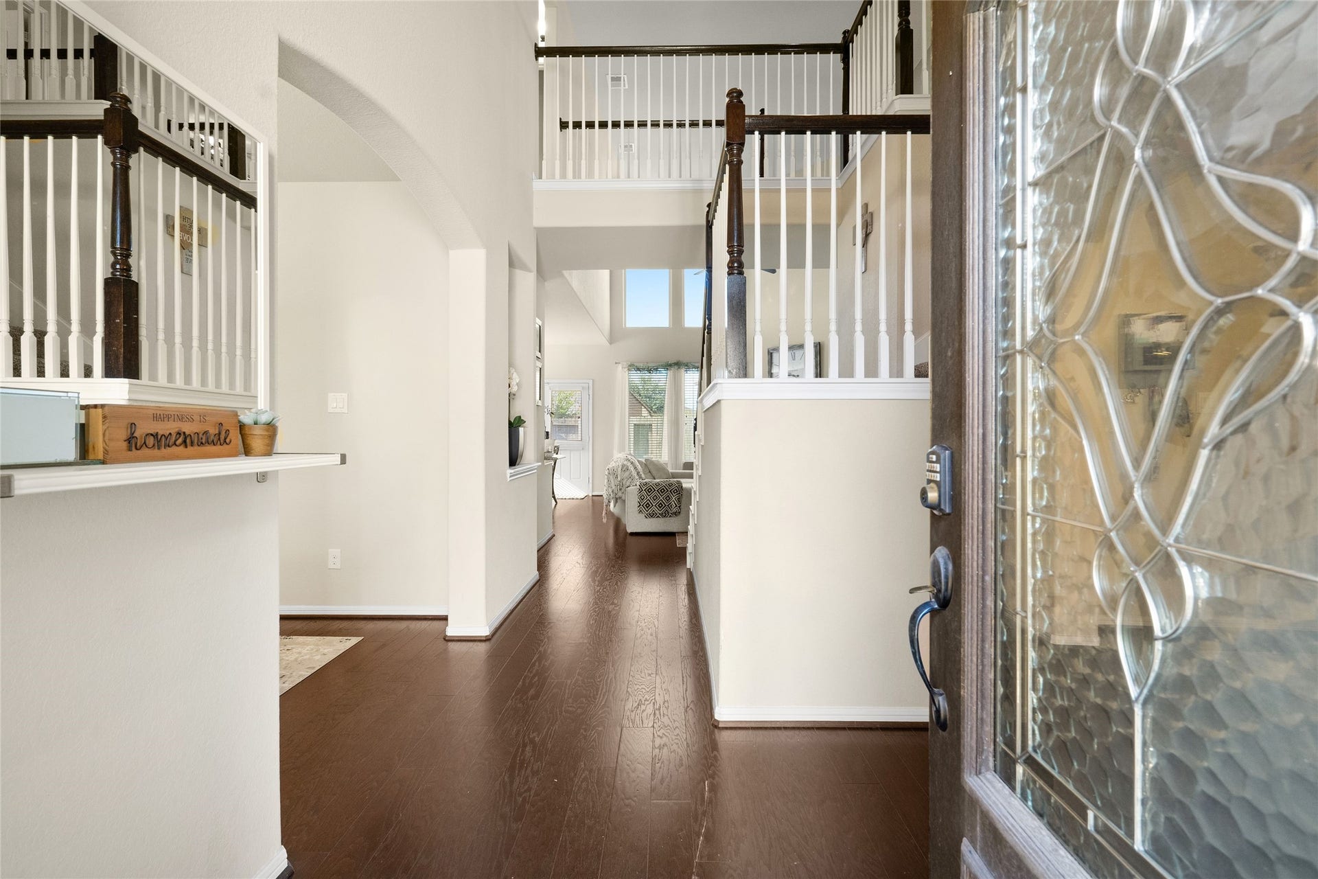 3650 Daintree Park Drive, Katy, TX 77494 Inviting two-story foyer with elegant wood flooring leads to an open living space filled with natural light.