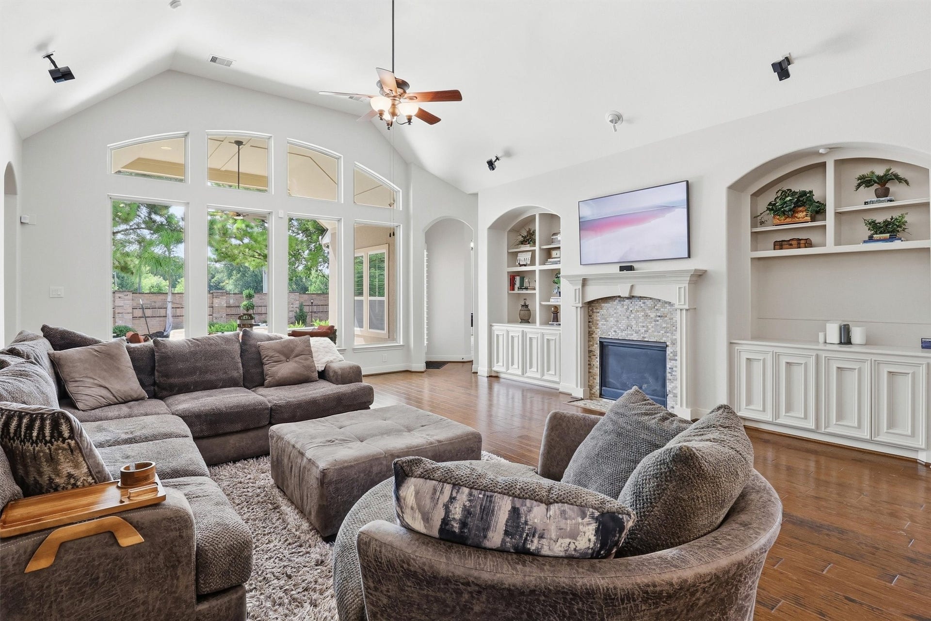 What a gorgeous, open space this is with a tiled fireplace with a classic mantle and double-ended built in's on either side, providing both beauty and storage.