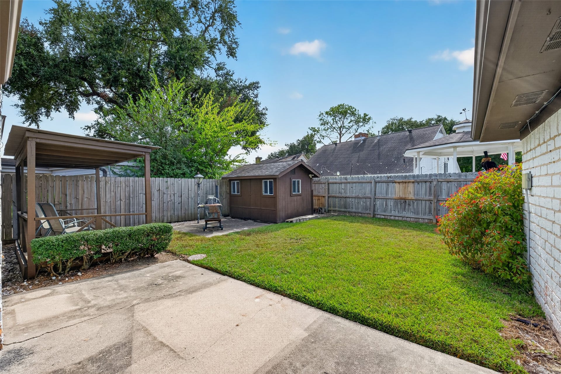 11414 Sagemeadow Lane, Houston, TX 77089 Backyard features patio, covered deck and storage building with electricity.