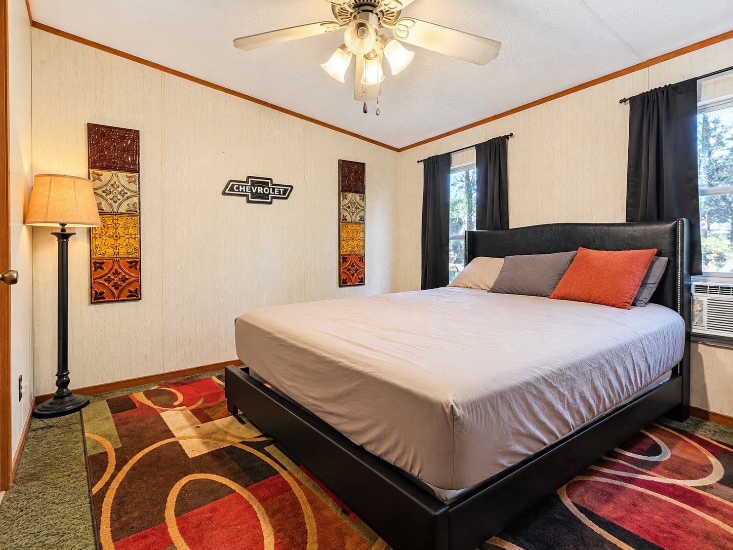 Virtually Edited  Secondary Bedroom: Spacious secondary bedroom featuring multiple windows, a ceiling fan, and plenty of room for furnishings.