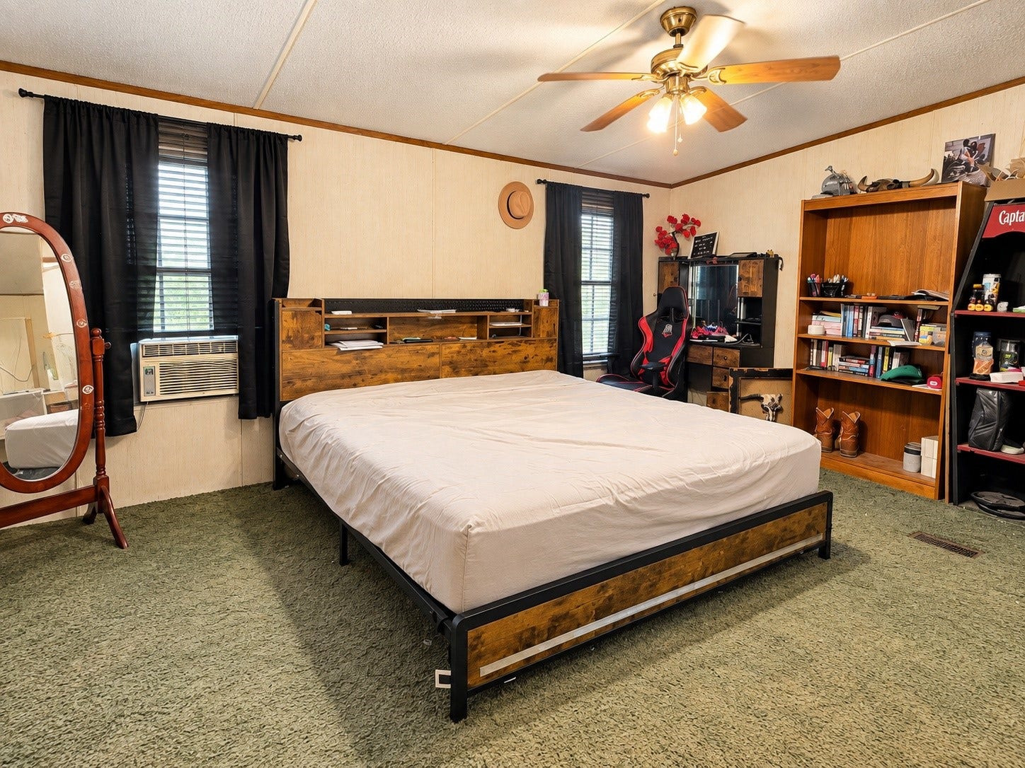 Virtually Edited  Primary Bedroom: Spacious primary bedroom featuring multiple windows, a ceiling fan, and plenty of room for additional furnishings and storage.