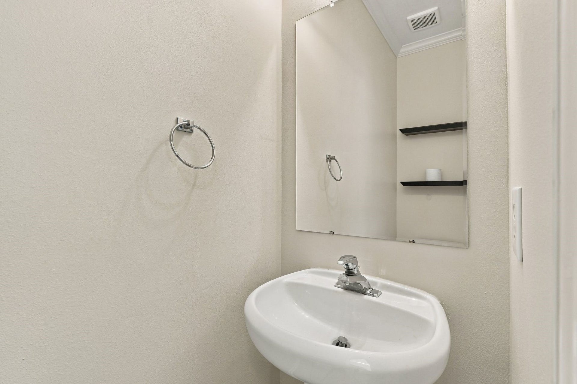 142 N Camellia Grove Circle, The Woodlands, TX 77382 This first floor half bath is behind the door next to the stairs.