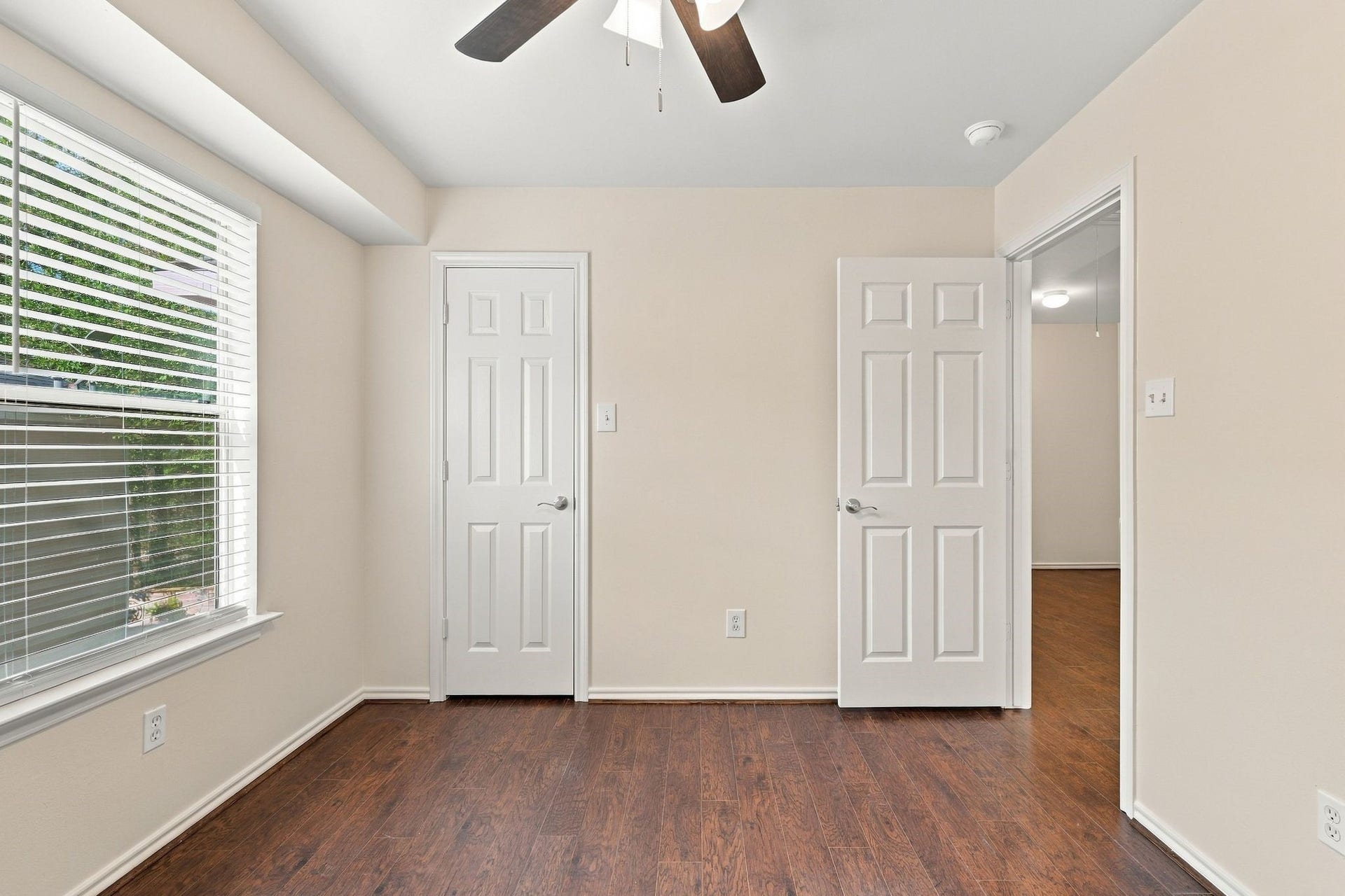 142 N Camellia Grove Circle, The Woodlands, TX 77382 Bedroom number 2 has the wood look flooring, new paint and new ceiling fan.