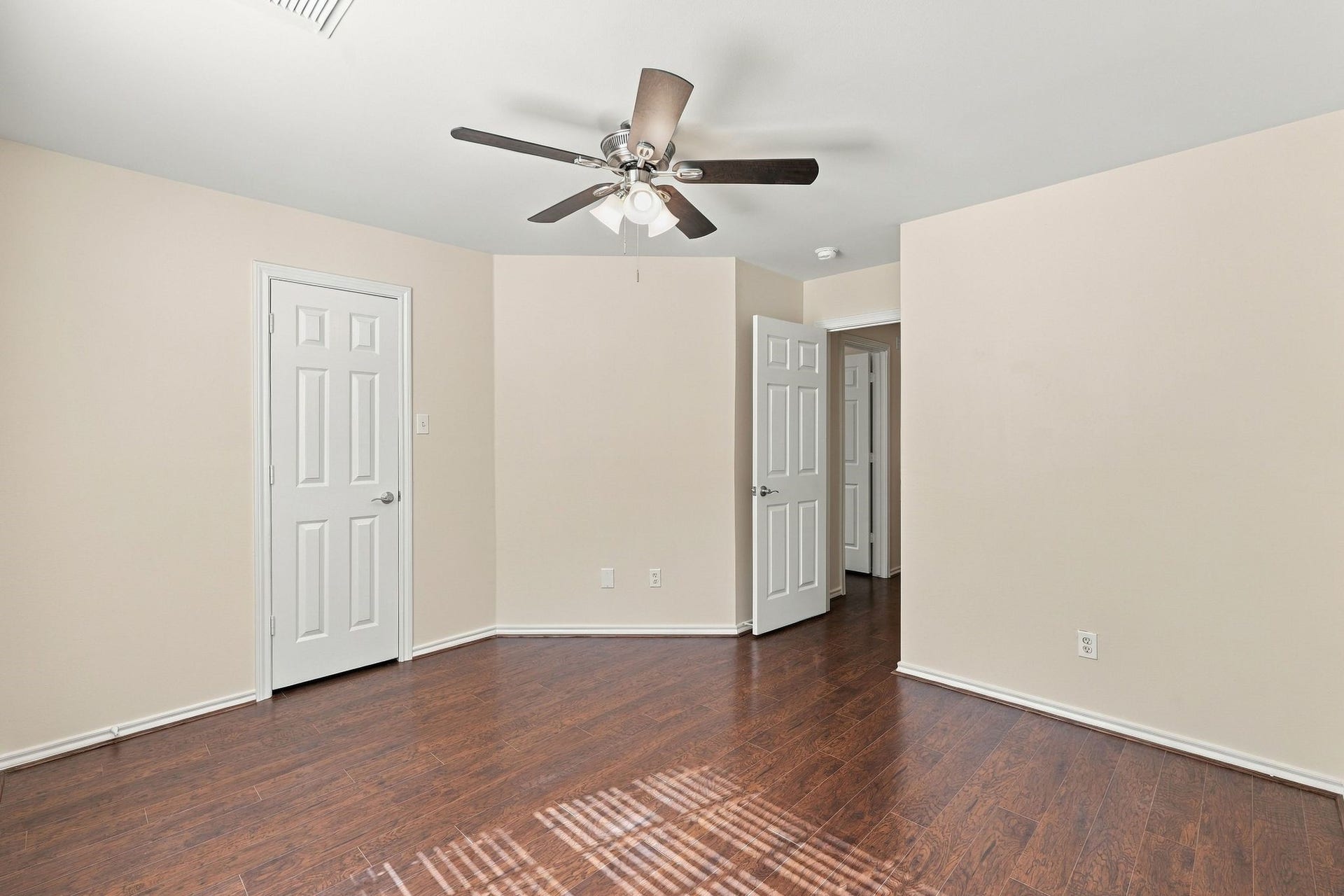 142 N Camellia Grove Circle, The Woodlands, TX 77382 Bedroom number 3 has wood look flooring, new paint and new ceiling fan.
