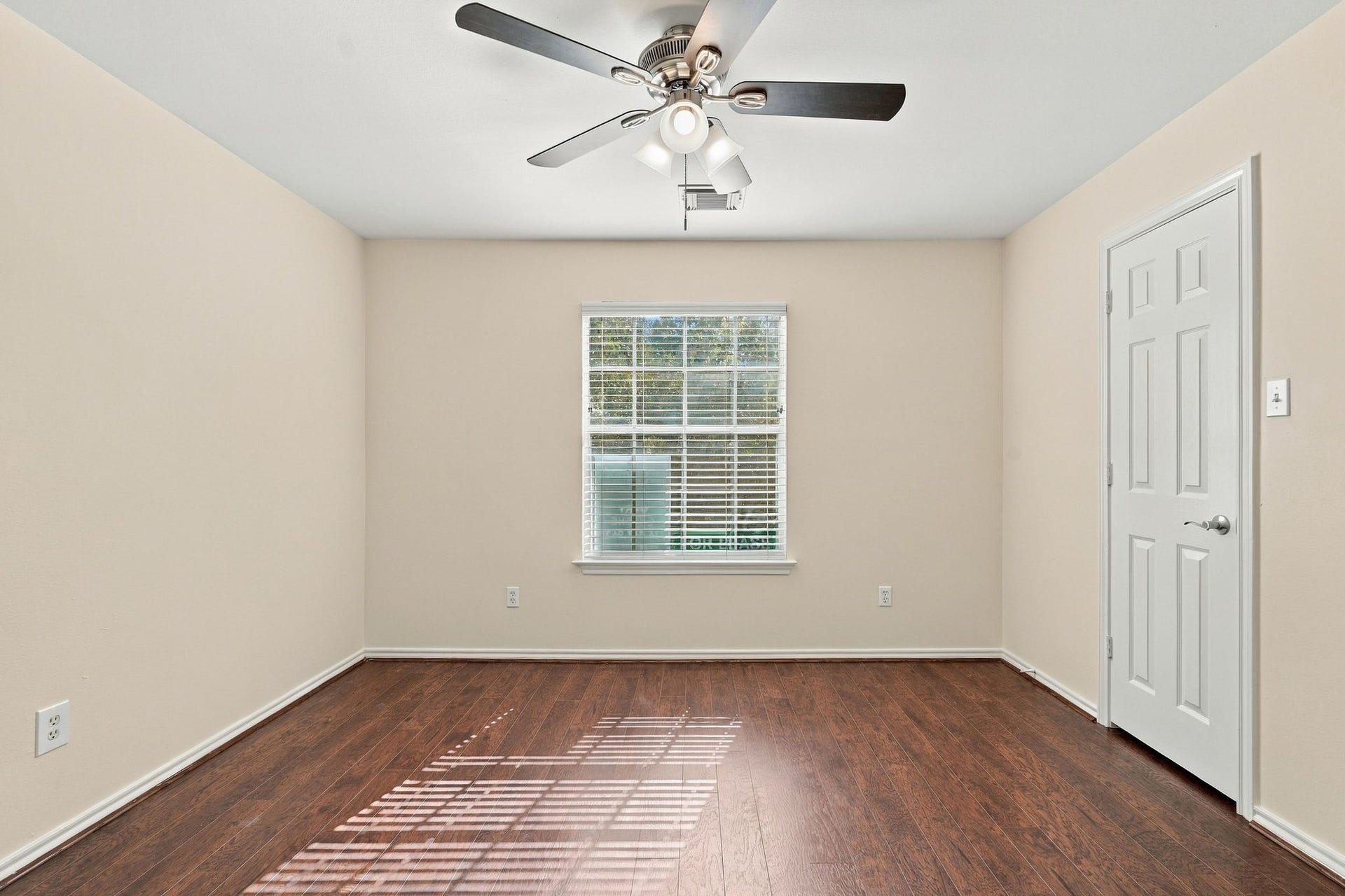 142 N Camellia Grove Circle, The Woodlands, TX 77382 Bedroom number 3 has wood look flooring, new paint and new ceiling fan.