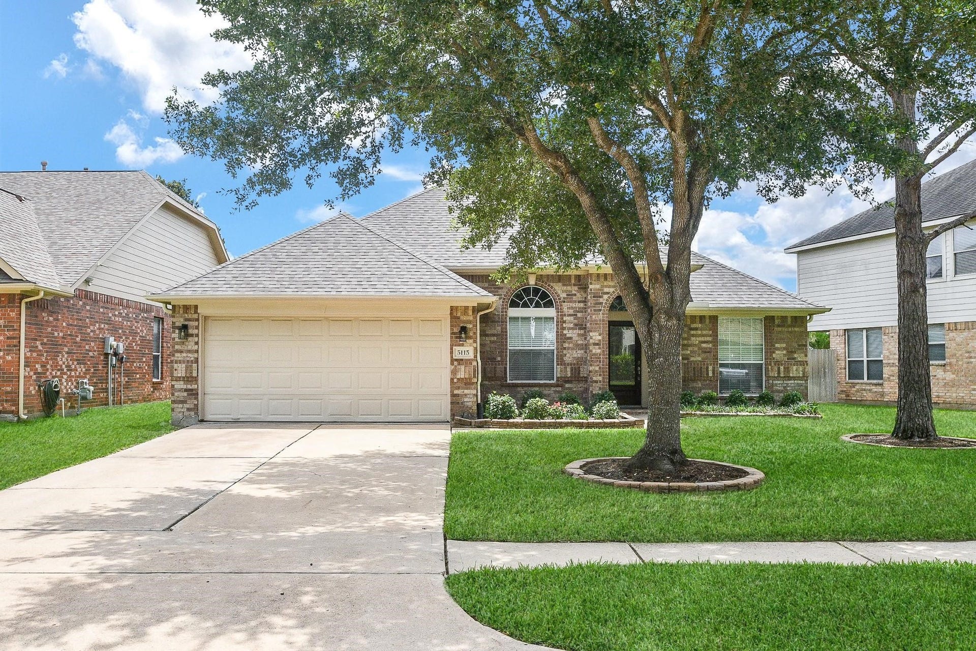 5115 Big Meadow Lane, Katy, TX 77494 Wonderful curb appeal with an arched entry and lots of shade from the mature trees. Roof replaced in 2023.