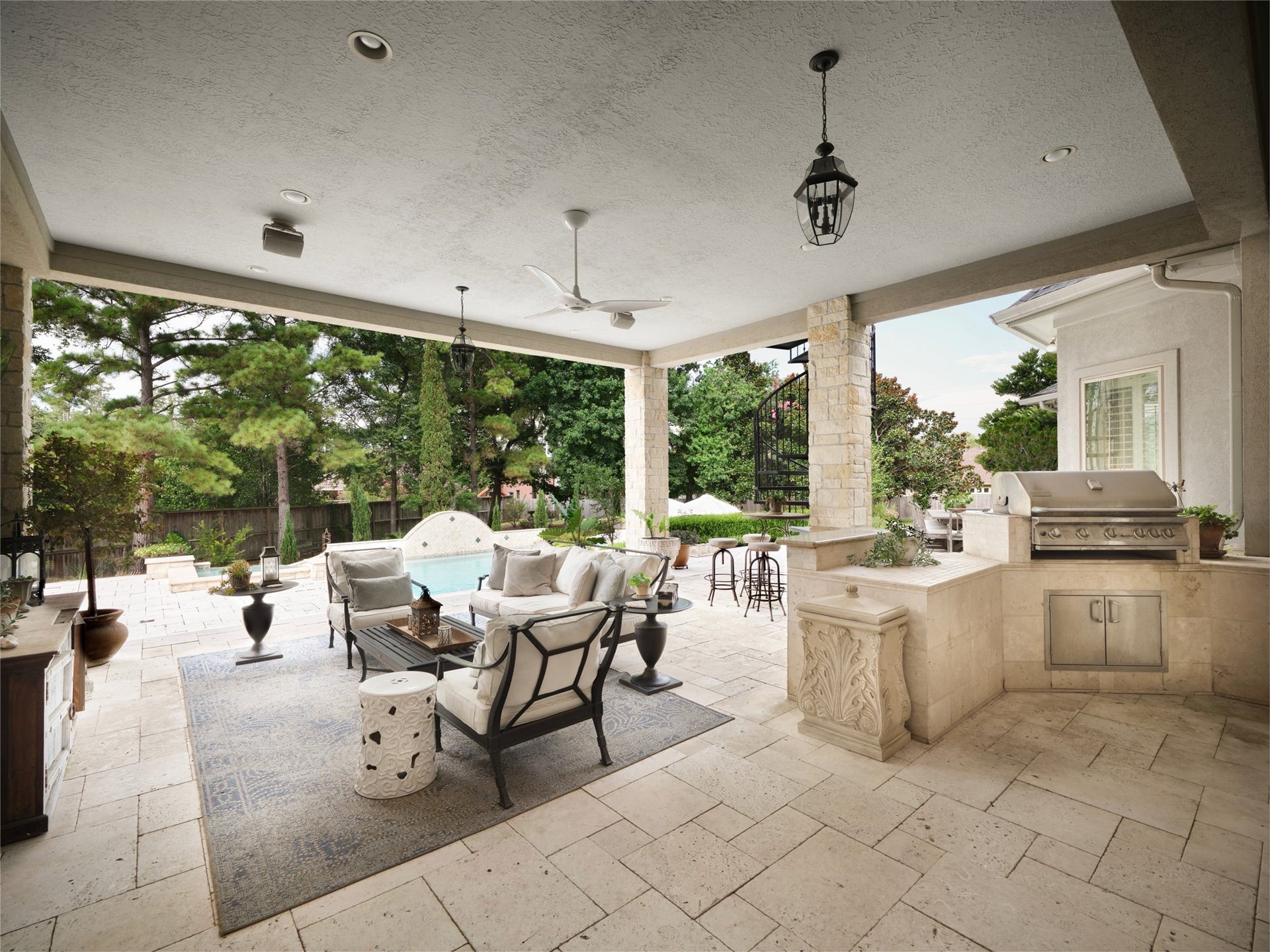6702 Star Ledge Court, Spring, TX 77389 COVERED OUTDOOR Living Designed for year-round enjoyment, the expansive covered outdoor living area seamlessly extends the homes interior gathering spaces. A built-in grilling station, generous seating areas, and limestone architectural details overlook the beautifully curated outdoor living environment and custom pool, creating an inviting setting for alfresco dining, entertaining, or quiet evenings with family and friends. Thoughtfully designed for both comfort and connection.