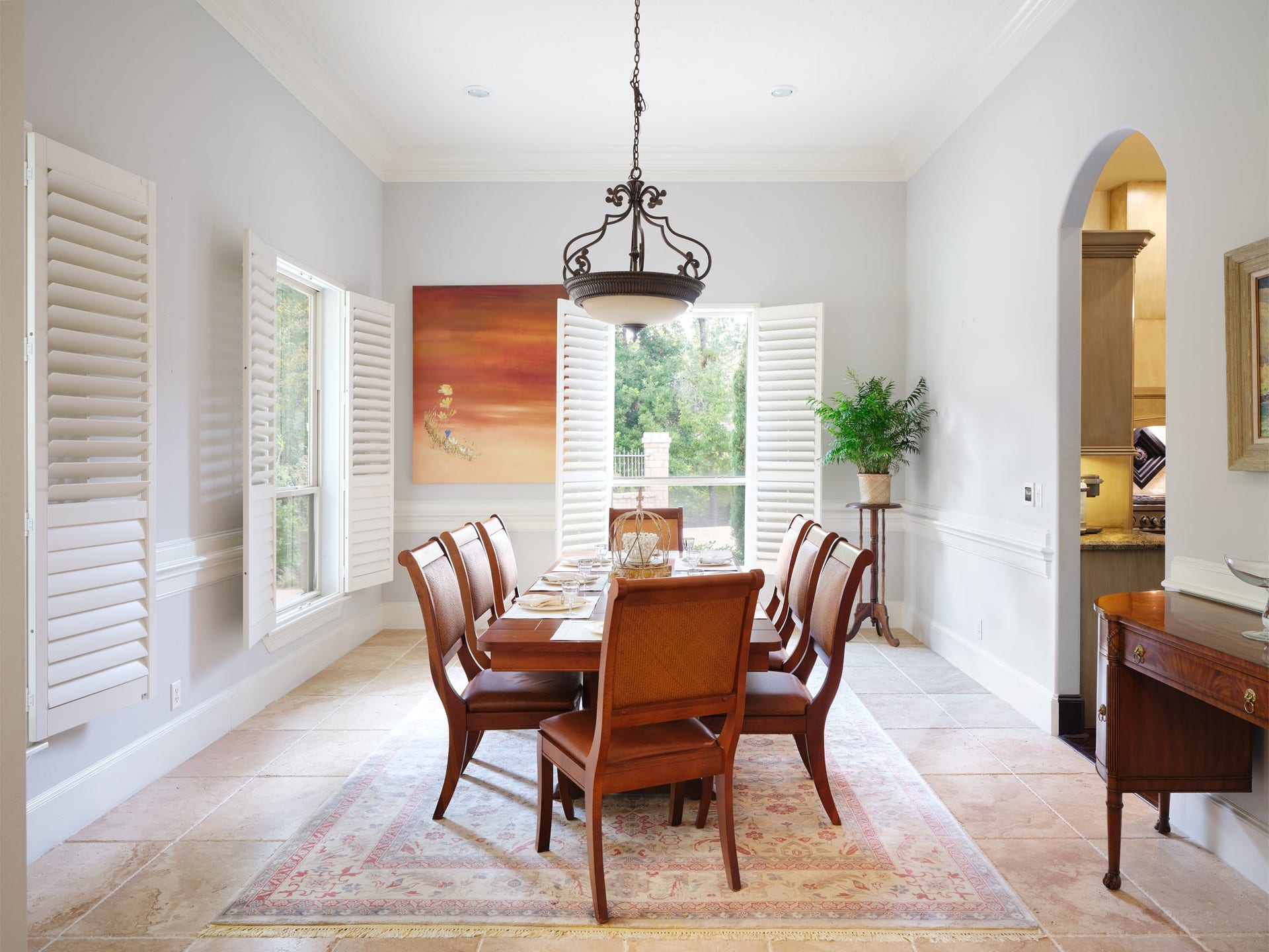 6702 Star Ledge Court, Spring, TX 77389 FORMAL DINING ROOM Elegantly proportioned and filled with natural light, the formal dining room features soaring ceilings, plantation shutters, travertine flooring, and serene views of the surrounding landscape. Designed to accommodate intimate family dinners or sophisticated entertaining, this gracious space reflects the timeless architecture found throughout the home.