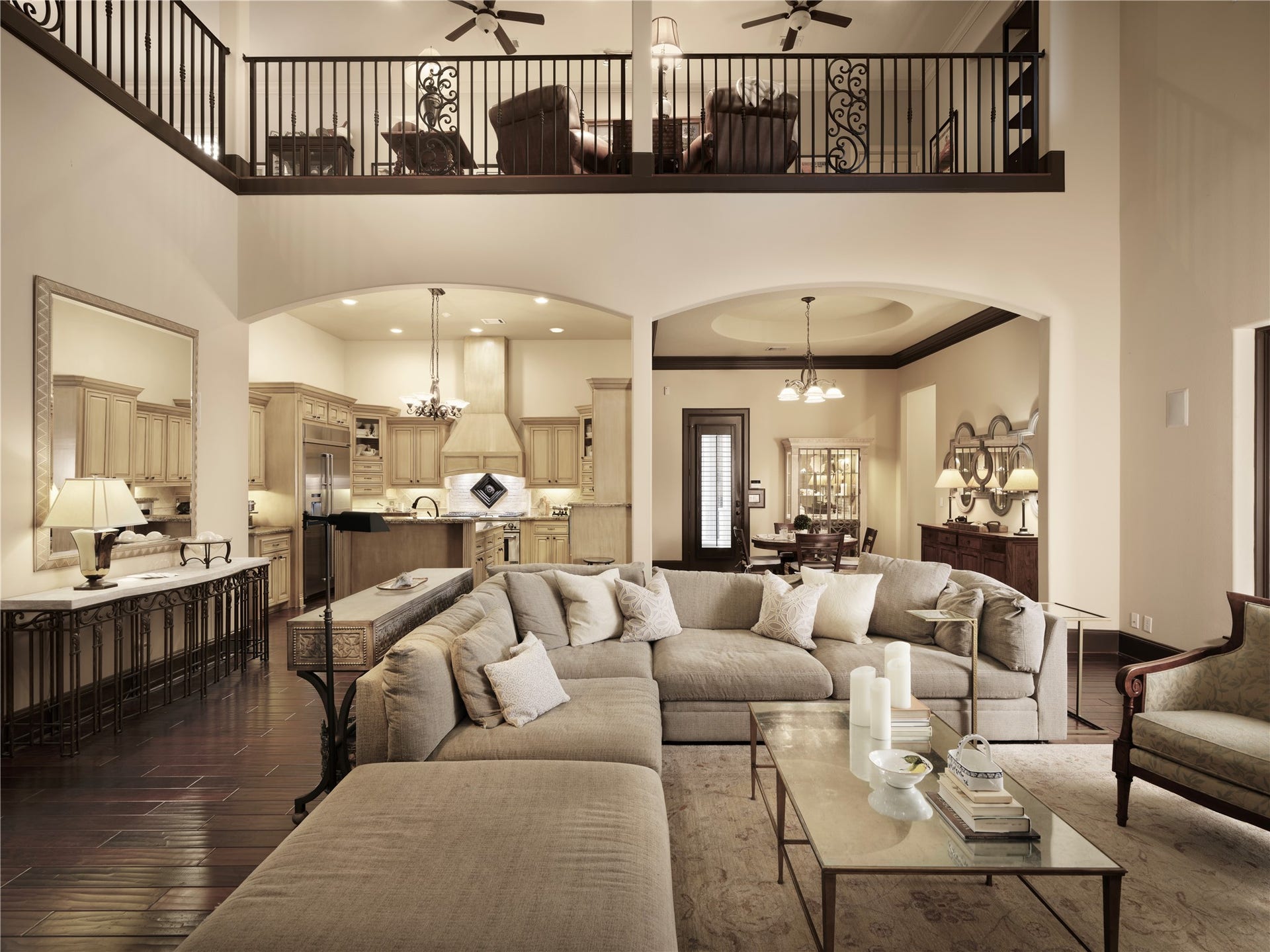 6702 Star Ledge Court, Spring, TX 77389 GREAT ROOM Serving as the heart of the home, the dramatic two-story Great Room is defined by soaring ceilings, expansive windows, and an open architectural design that seamlessly connects the kitchen, dining areas, and upper-level entertainment spaces. Rich hardwood floors, elegant detailing, and generous proportions create a warm yet sophisticated setting for everyday living and grand-scale entertaining. Flooded with natural light, this inviting gathering space offers both impressive scale and an effortl