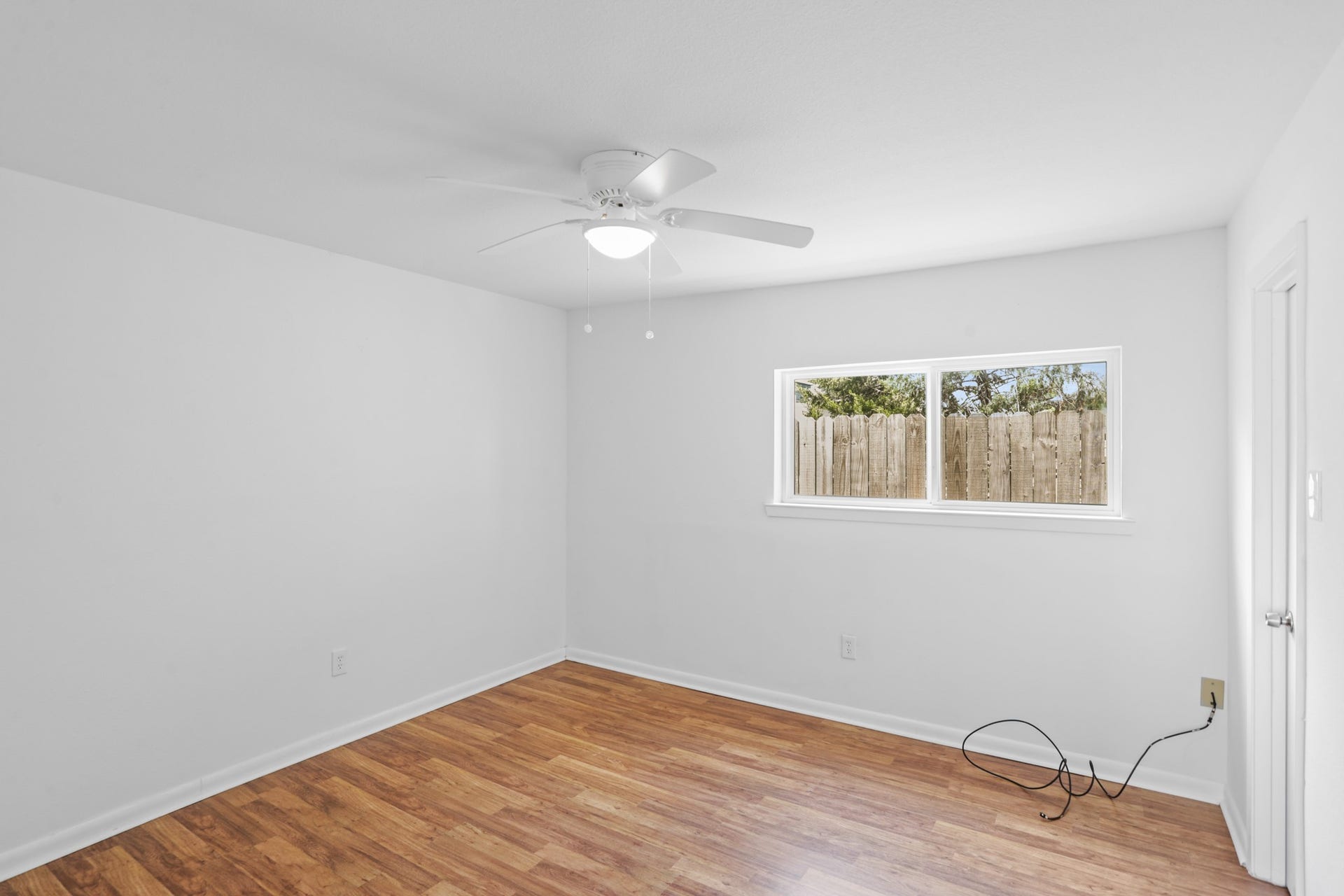 1408 Hughes Street, #11, Houston, TX 77023 The bedroom has updated windows, ceiling fan and laminate flooring.