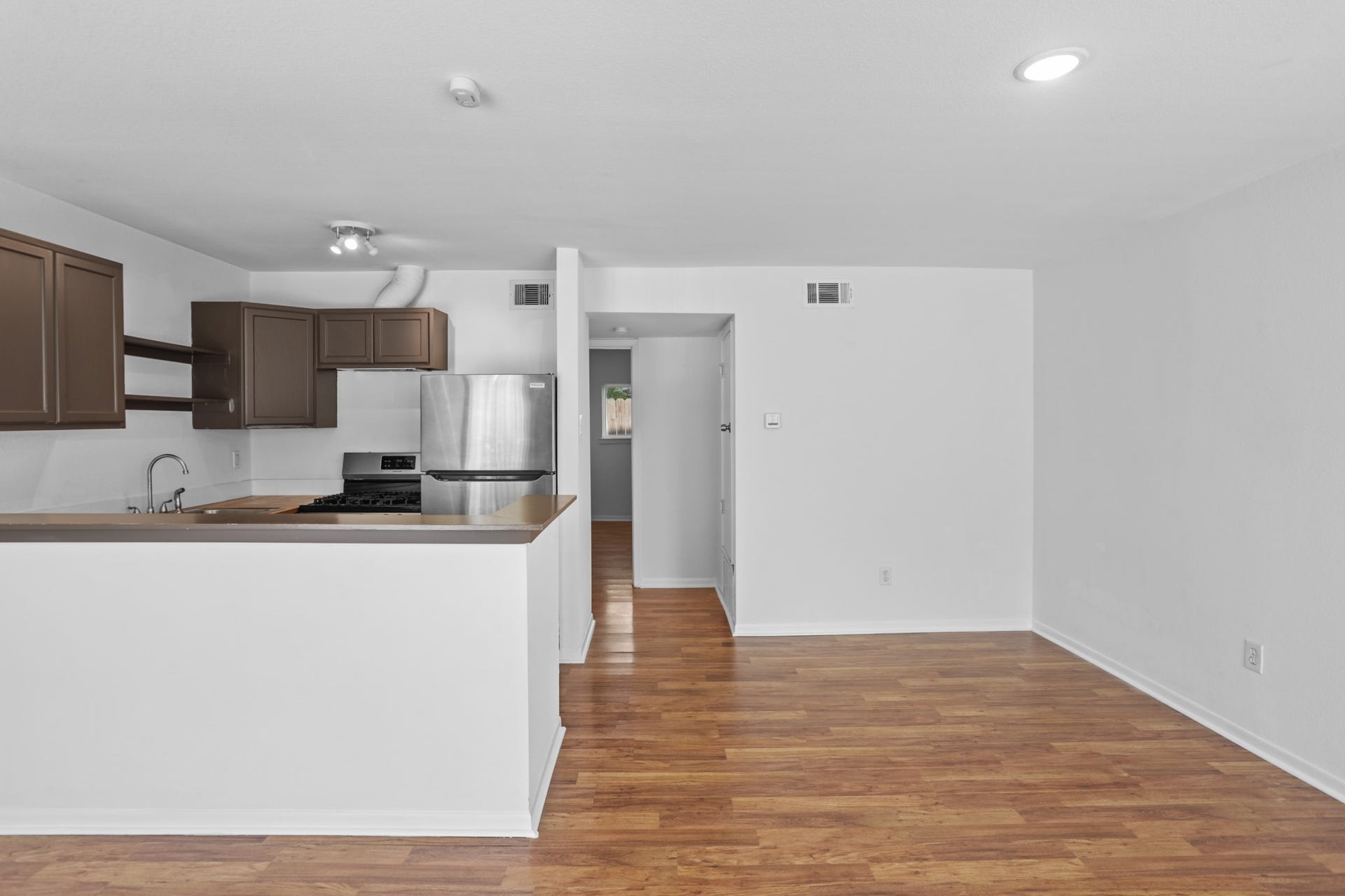 1408 Hughes Street, #11, Houston, TX 77023 The living area and kitchen flow together seamlessly.