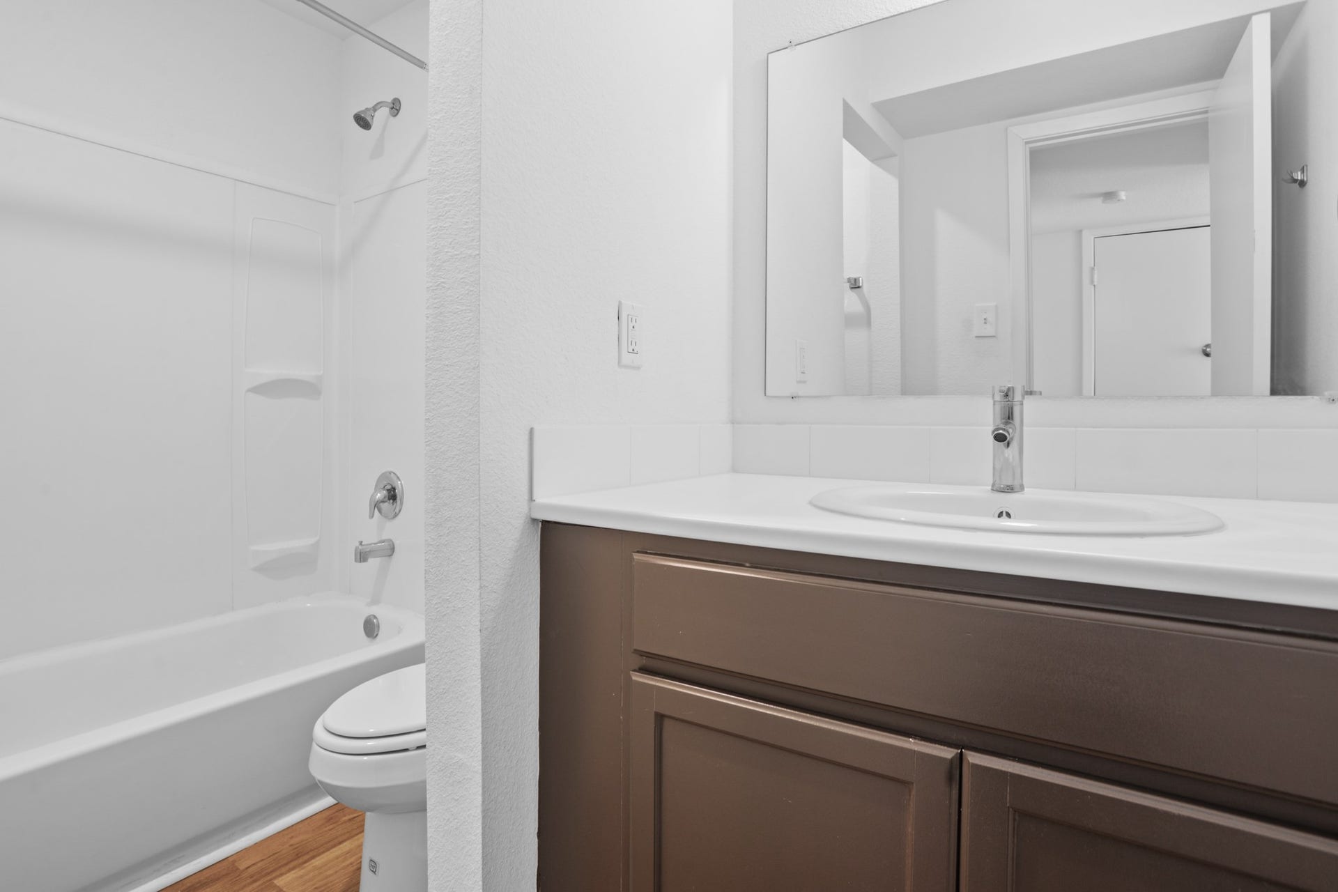 1408 Hughes Street, #11, Houston, TX 77023 The bathroom has been updated with quartz countertop, cabinetry, tub surround, sink and contemporary faucet.