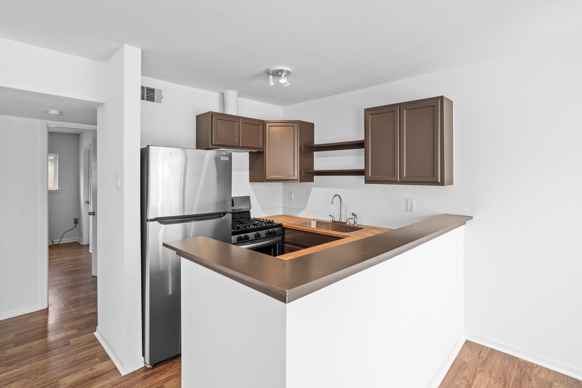1408 Hughes Street, #11, Houston, TX 77023 Recently updated kitchen with stainless steel appliances. The units include a refrigerator, stove and dishwasher.