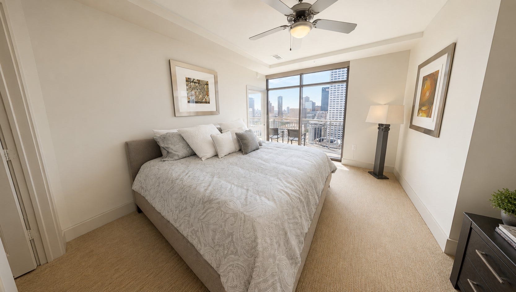 Imagine waking up with the city just outside your window. The primary bedroom enjoys beautiful natural light and direct access to the private balcony.