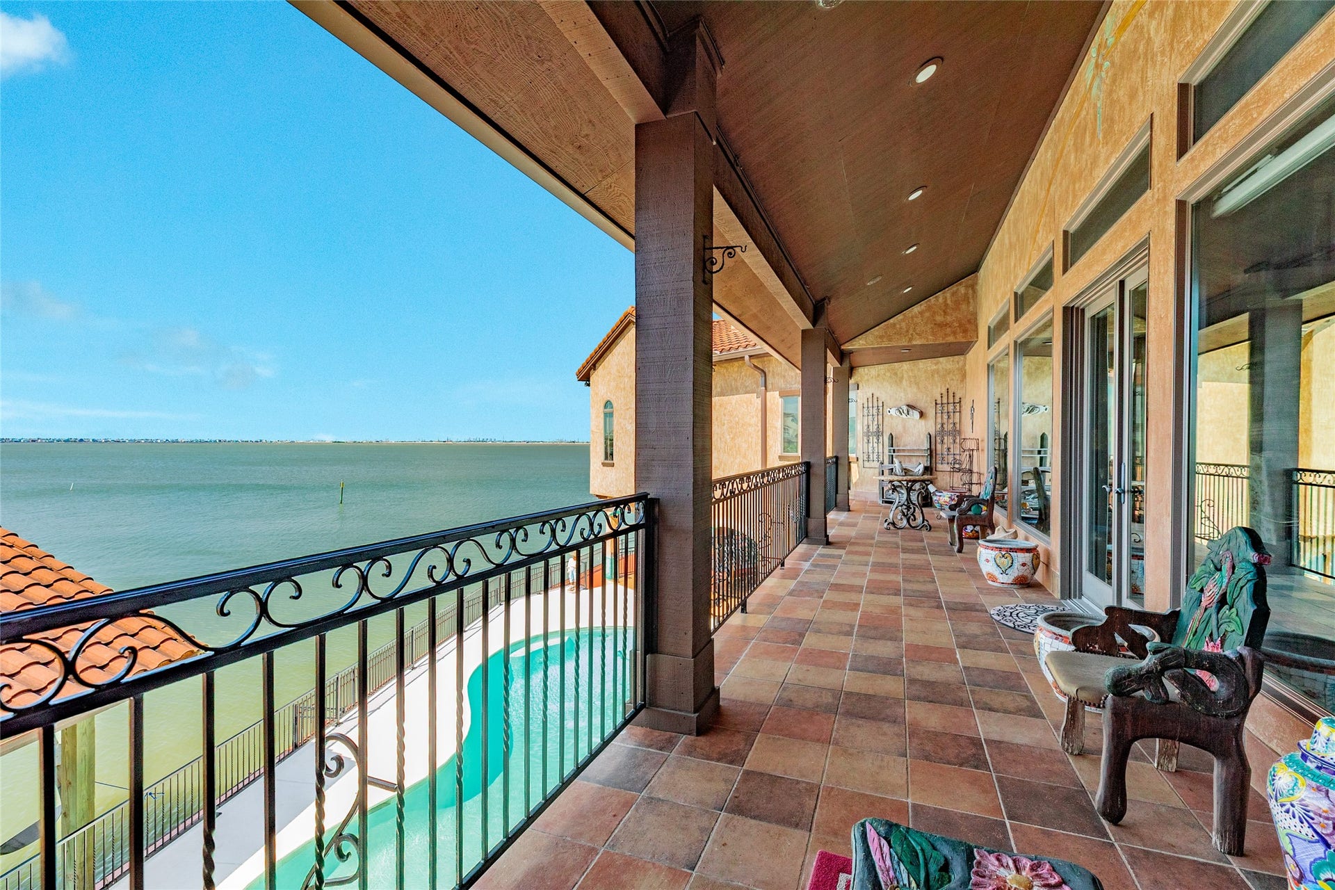 506 Sunset Circle, Tiki Island, TX 77554 Balcony off of living area, overlooking pool and bay