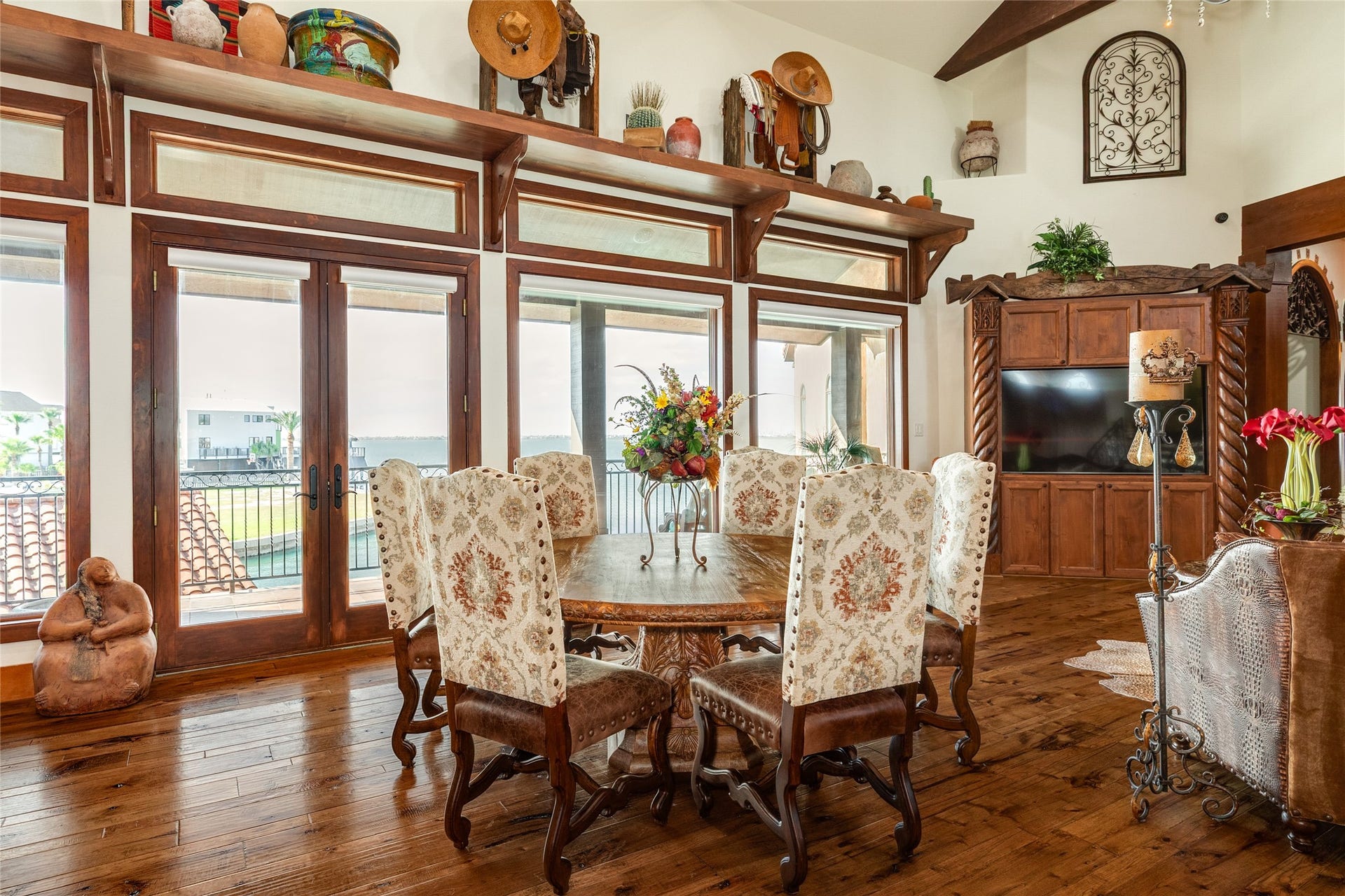 506 Sunset Circle, Tiki Island, TX 77554 Dining area located between two seating areas, with views of the bay