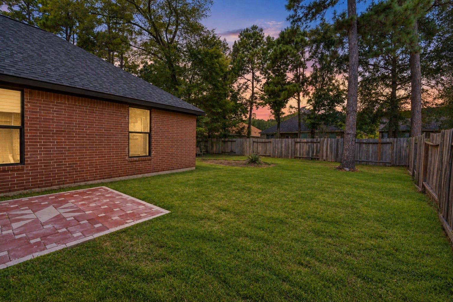 18 Griffin Hill Court, The Woodlands, TX 77382 The rear exterior of 18 Griffin Hill Court is a private outdoor sanctuary, surrounded by mature trees and established landscaping that provide natural shade and excellent privacy. The well-maintained brick facade continues beautifully along the back of the home, while the spacious backyard offers wonderful potential for outdoor living and recreation.