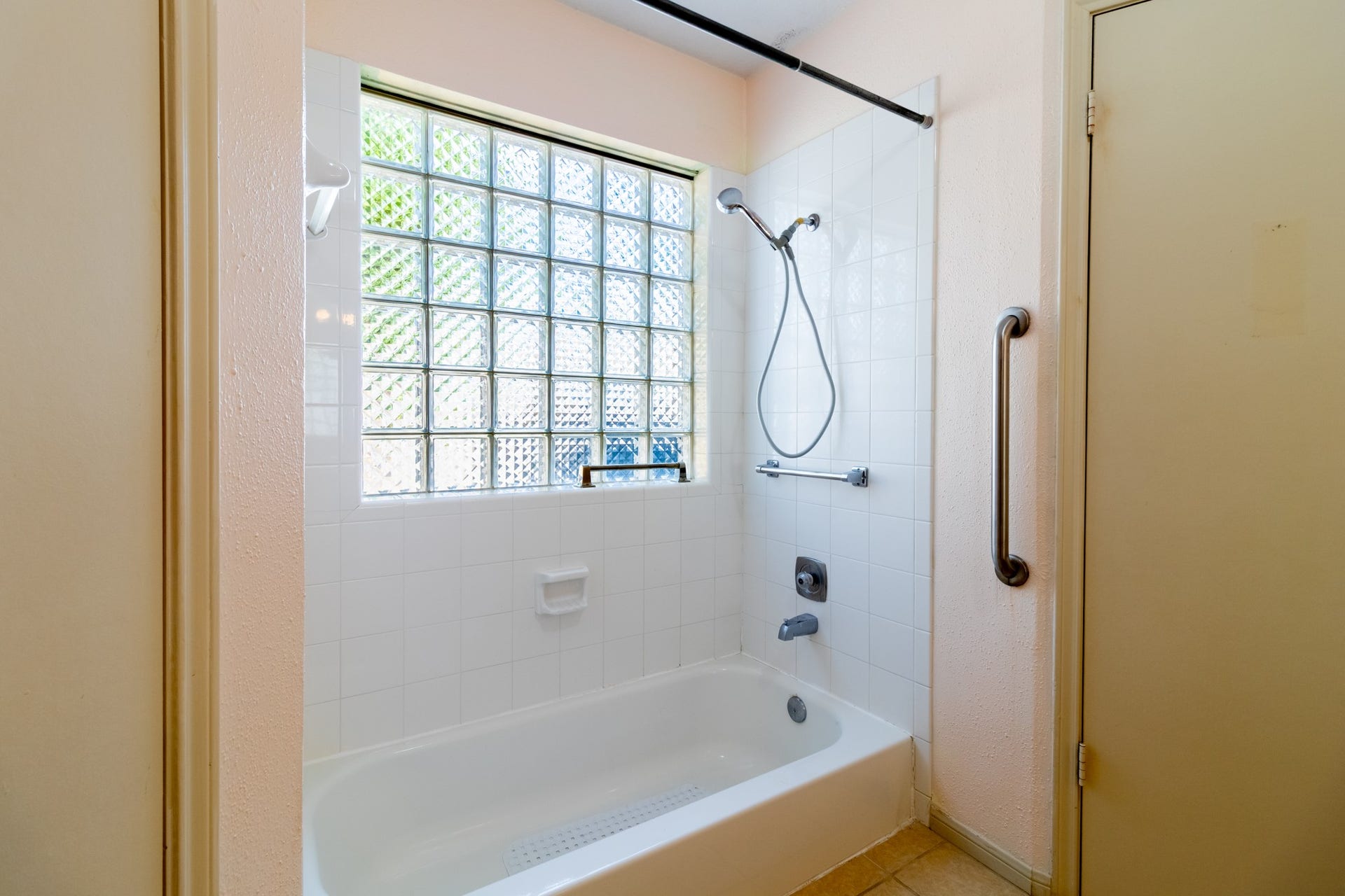 Imagine turning this bathing area into a relaxing escape, with natural light filtering through the glass-block window.