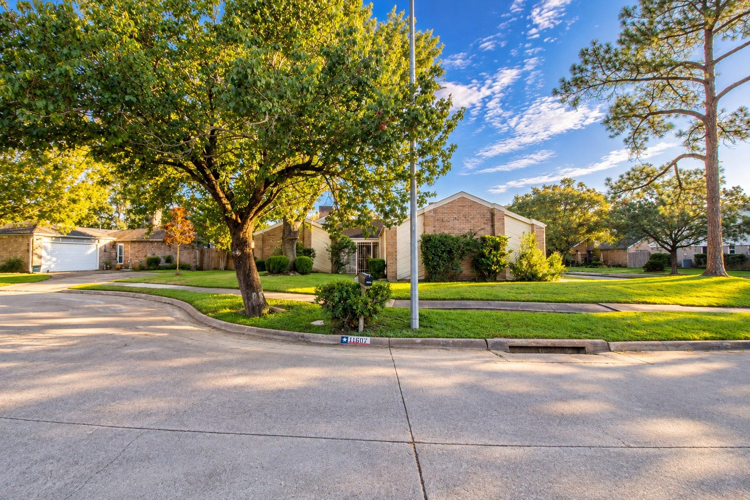 Mature trees and a corner setting create an inviting backdrop for the home you've been dreaming of making your own.