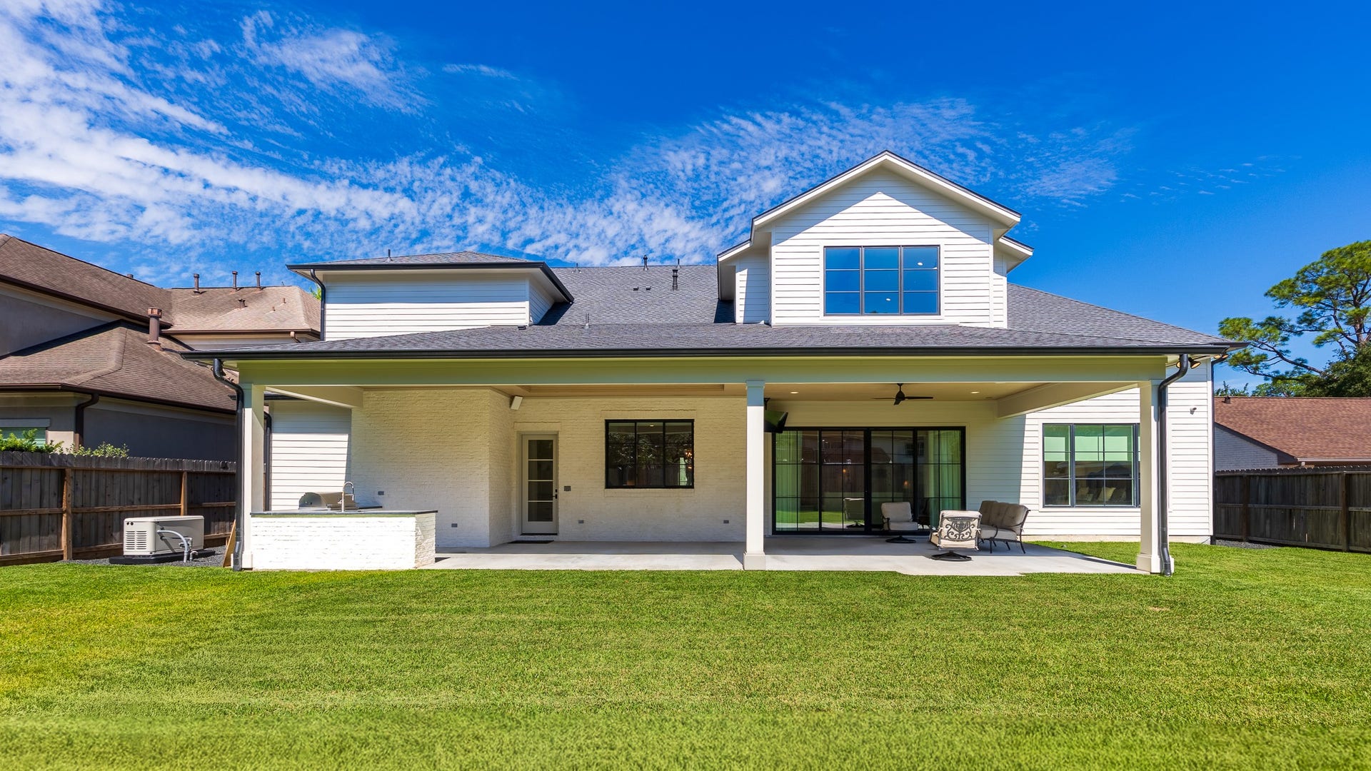 13915 Queensbury Lane, Houston, TX 77079 Enjoy an expansive backyard with plenty of green space for outdoor activities and entertaining. The impressive covered patio extends across the rear of the home, complemented by an outdoor kitchen and a Generac generator for added peace of mind.
